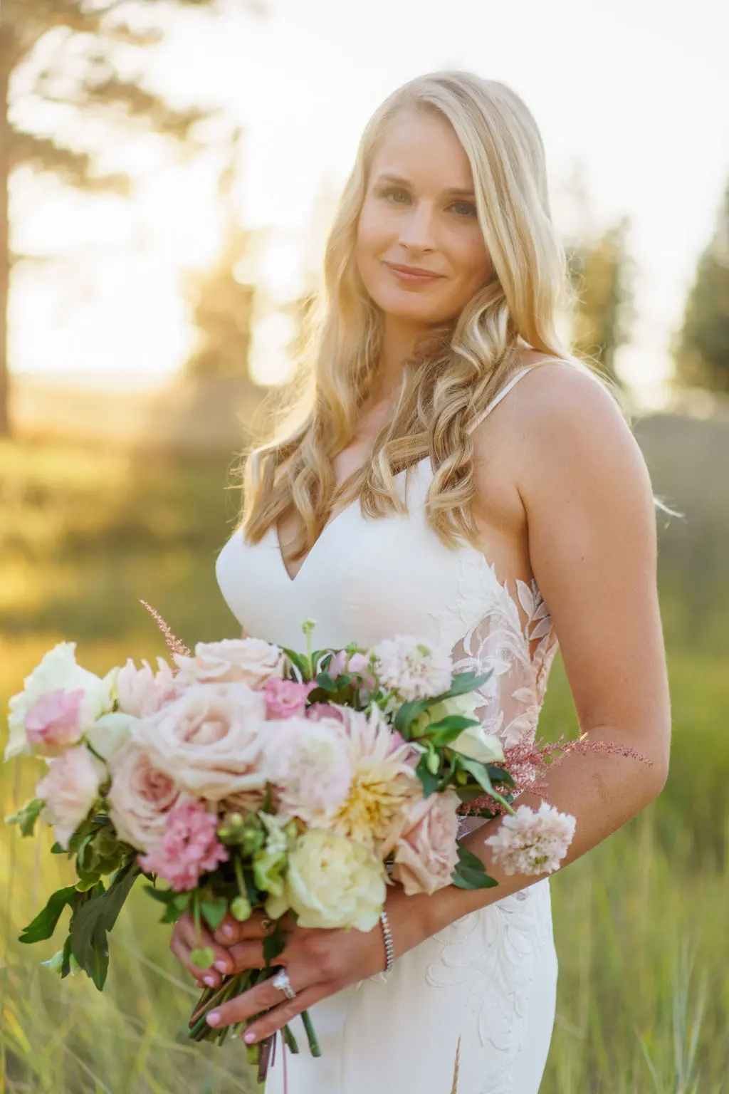 Bride wearing Dionne wedding dress by Rebecca Ingram holding a bouquet