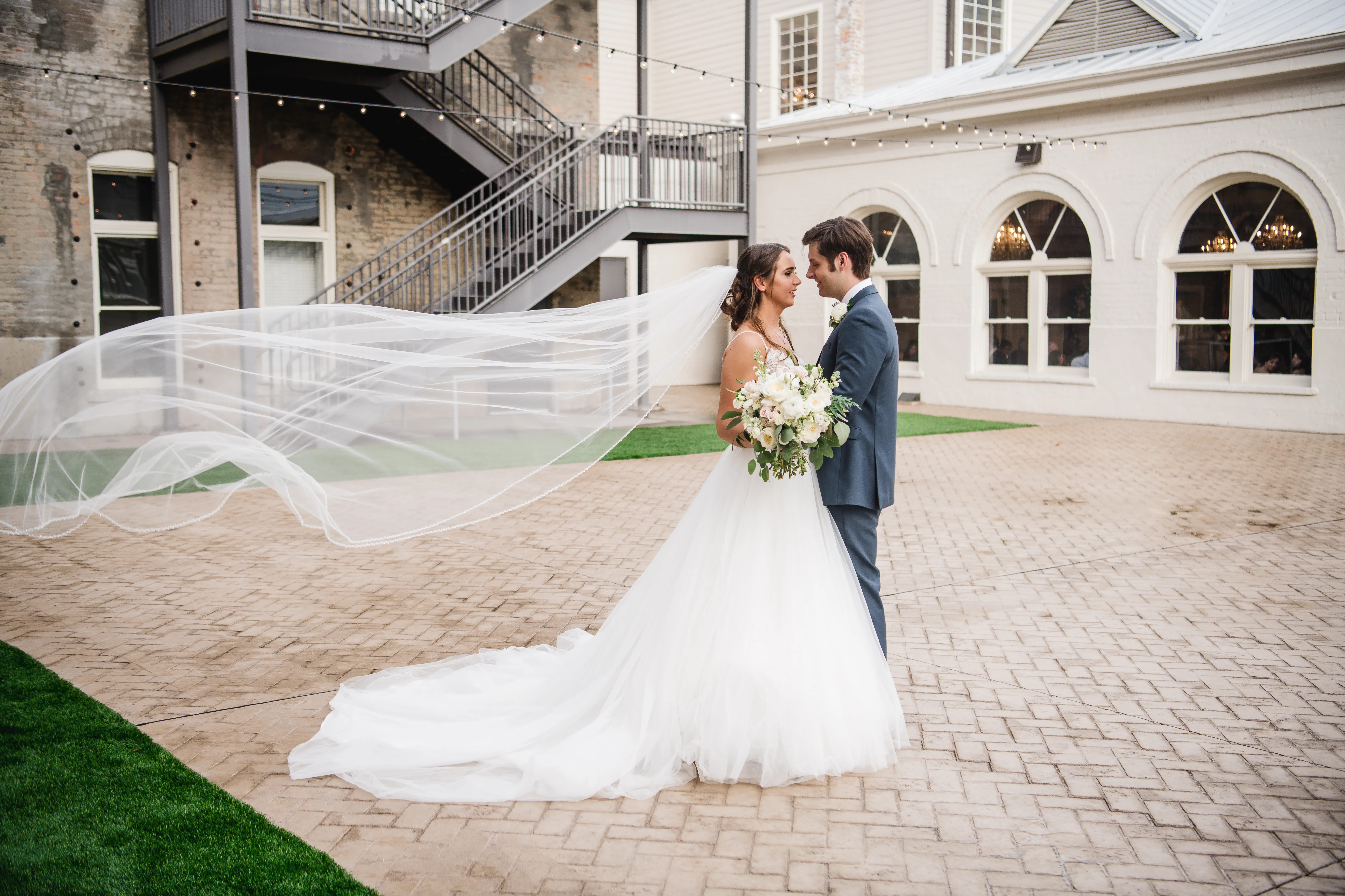 Bride wearing a boho princess wedding dress in lace and tulle