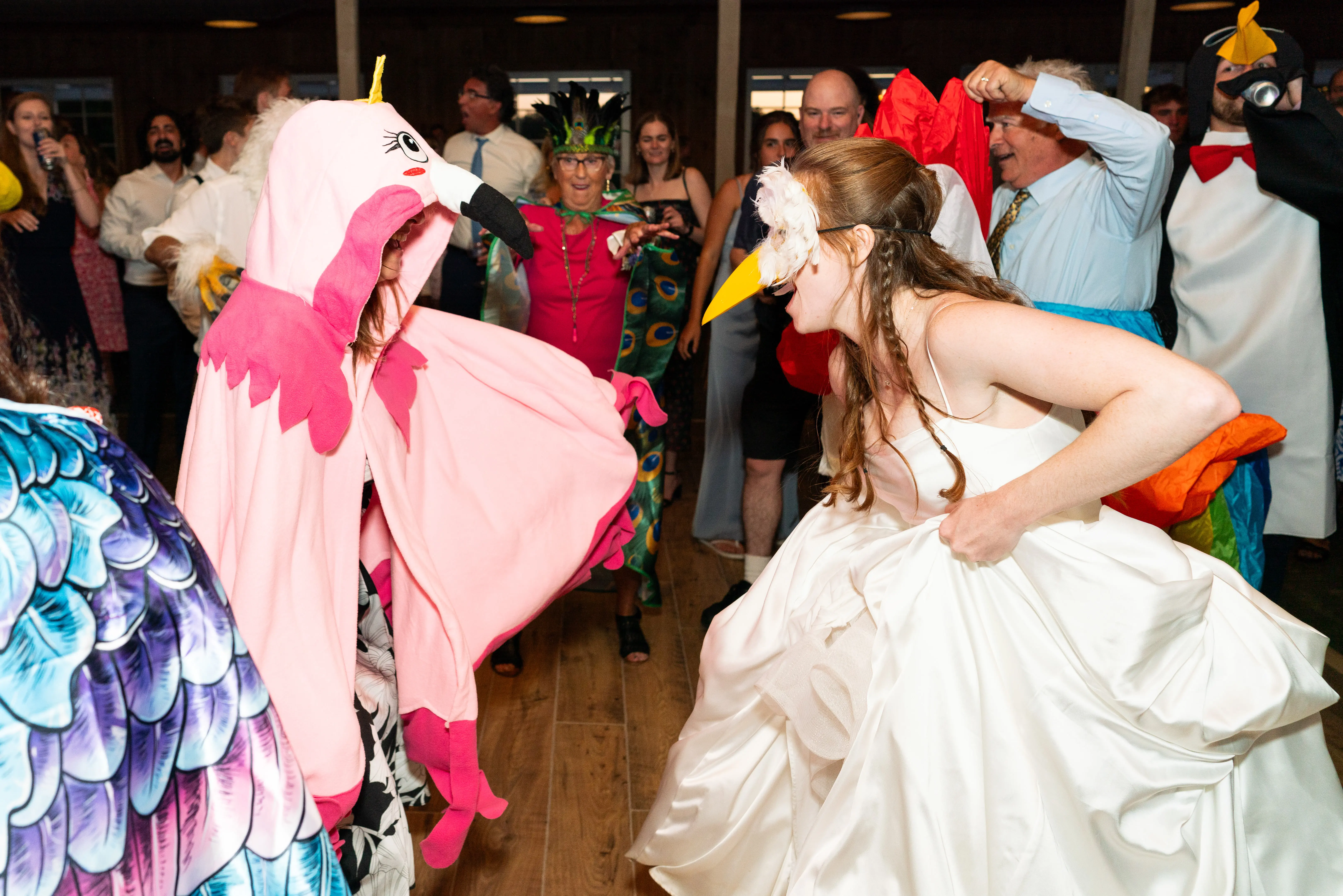 Bride wearing Scarlet by Maggie Sottero dancing with a bird mask on