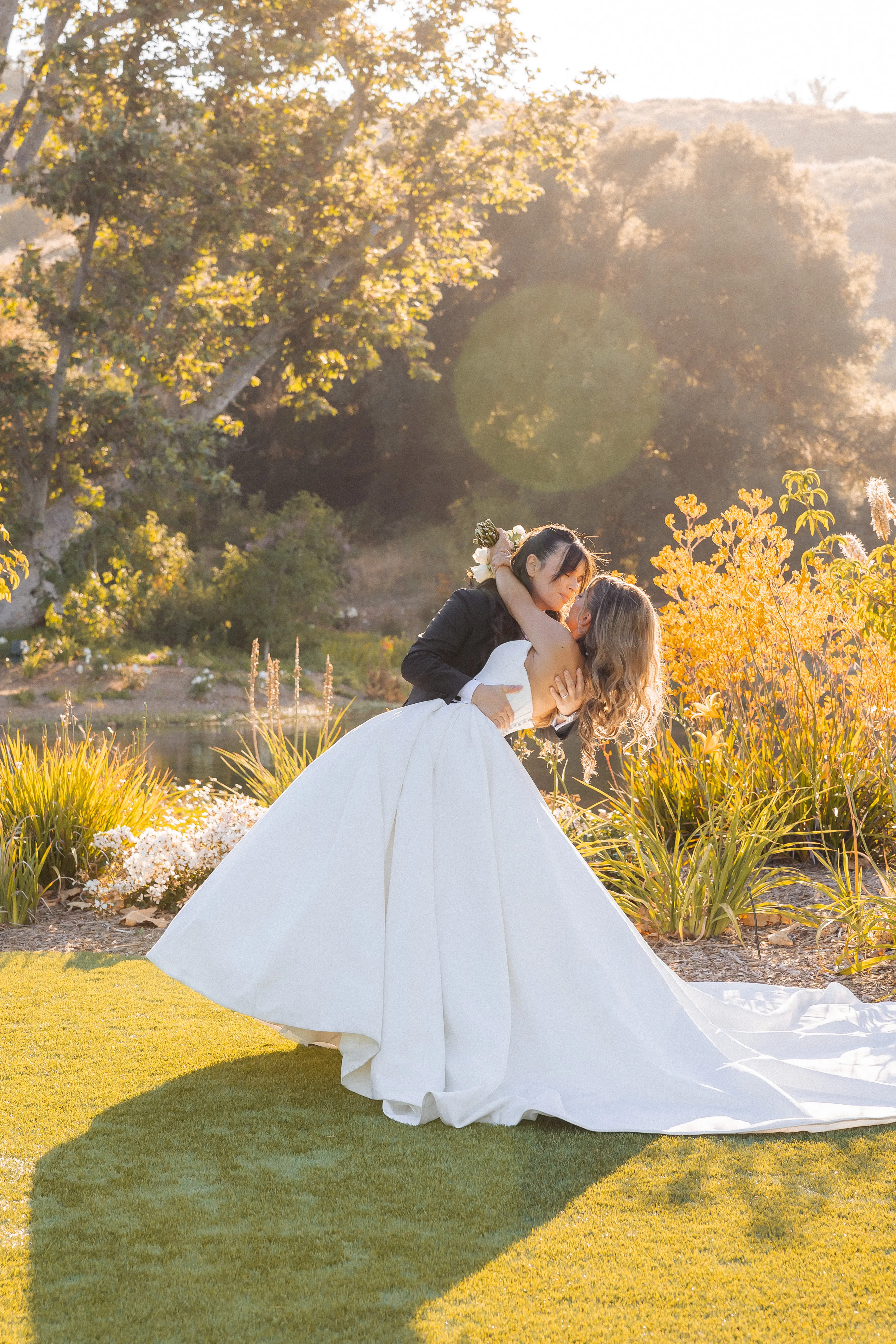 Bride wearing Derrick by Maggie Sottero being dipped by her partner
