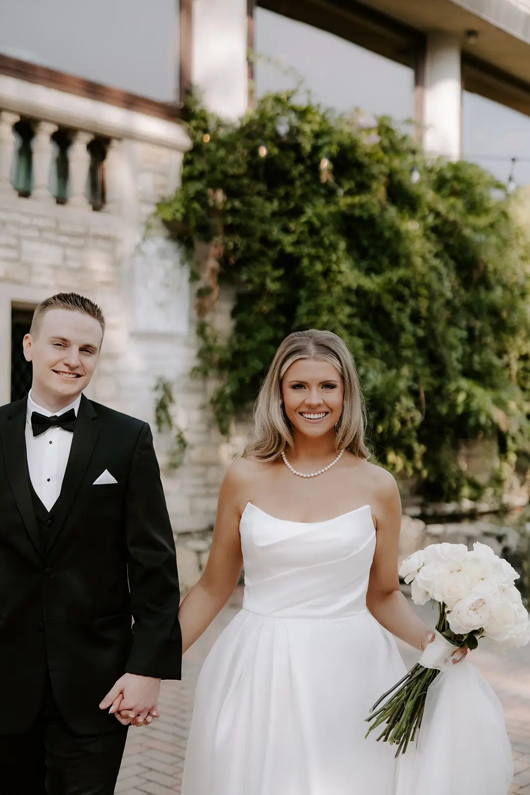 Bride Wearing Simple Aline Wedding Dress Called Aspen By Sottero And Midgley Holding Hands With Groom
