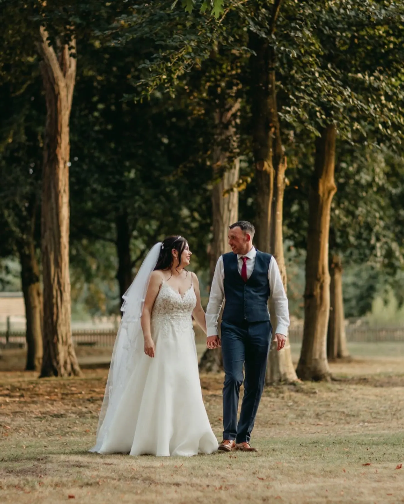 Bride Wearing Romantic Floral Wedding Dress With Lace Cutout Train Called Savannah By Maggie Sottero With Groom Surrounded By Trees