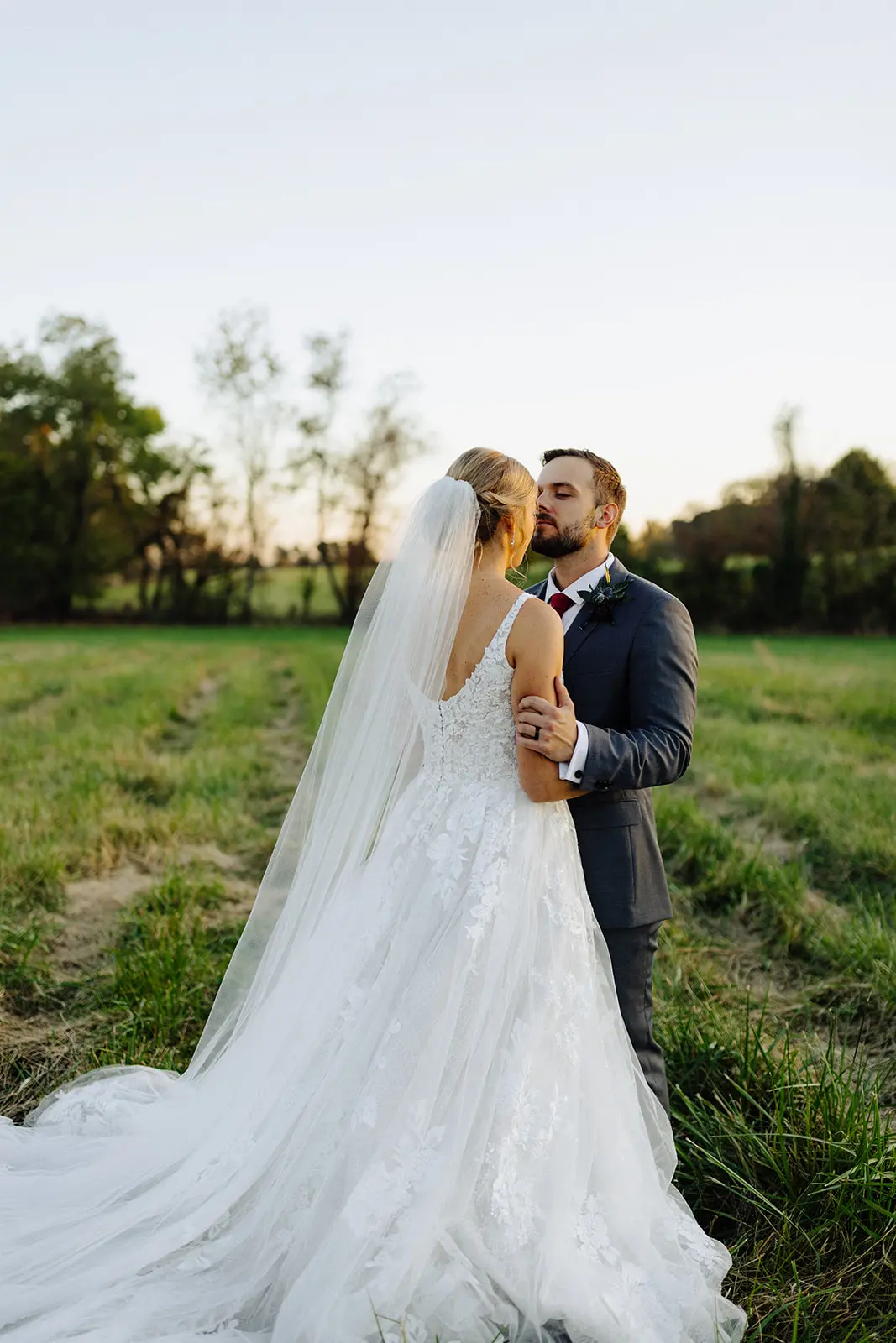 Groom with Bride at Outdoor Wedding Wearing Fairytale Ballgown Called Valona by Sottero and Midgley.