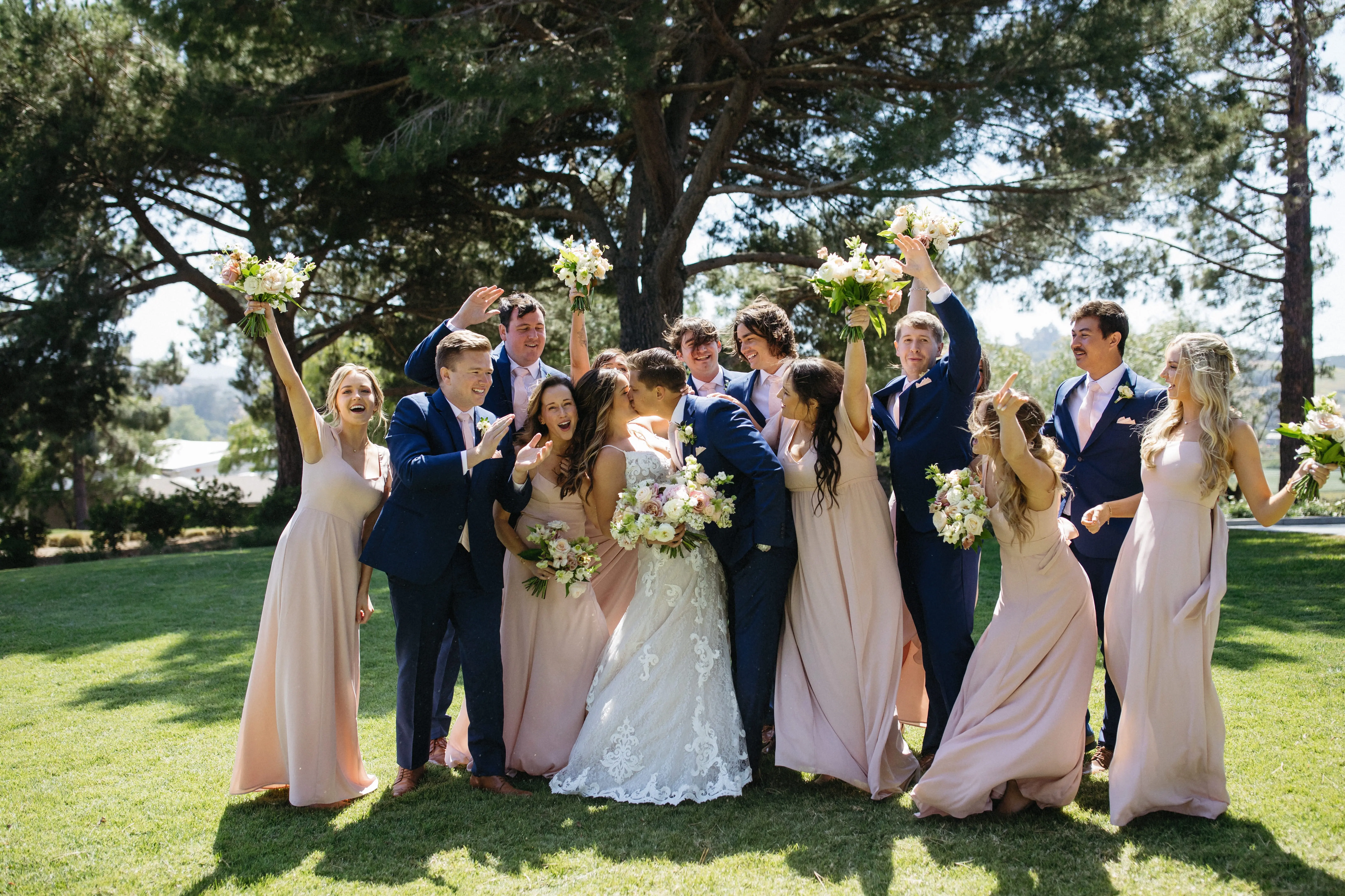 Bride with groom and wedding party wearing romantic, A-line wedding dress