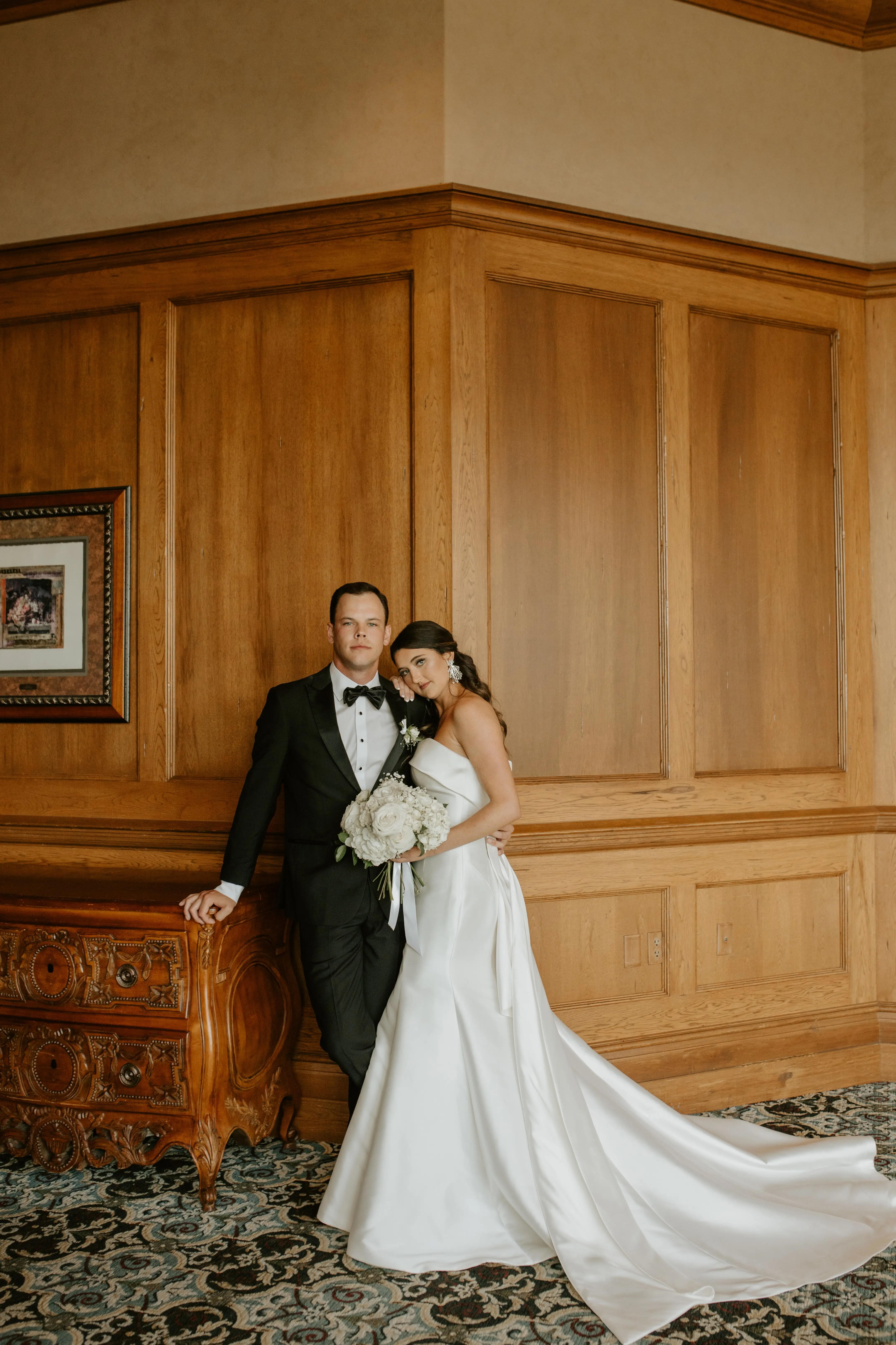 Groom With Bride Wearing Strapless Wedding Dress Featuring Big Bow Mitchell By Maggie Sottero