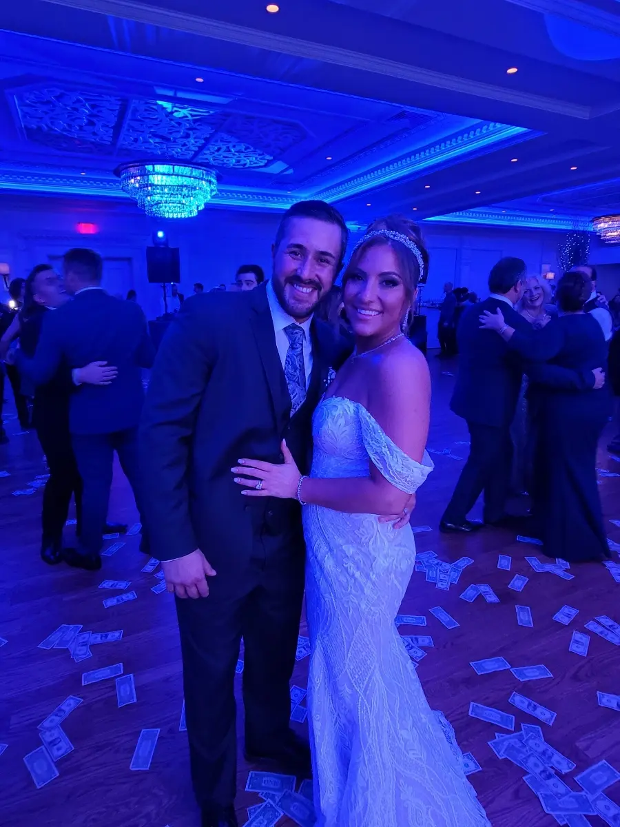 Bride wearing Bronson wedding dress by Sottero and Midgley with her husband at their reception