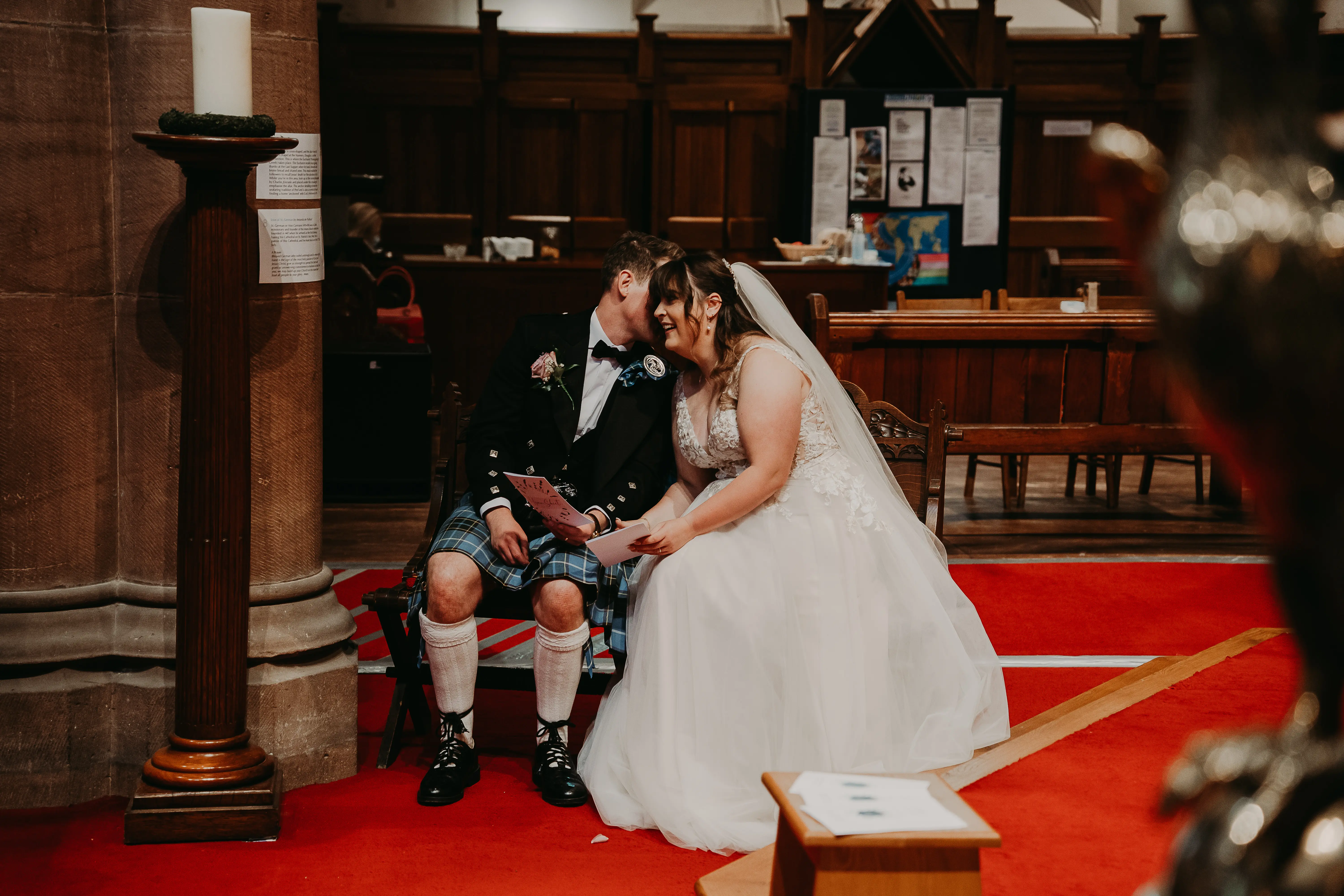 Groom whispering to his bride during the wedding.