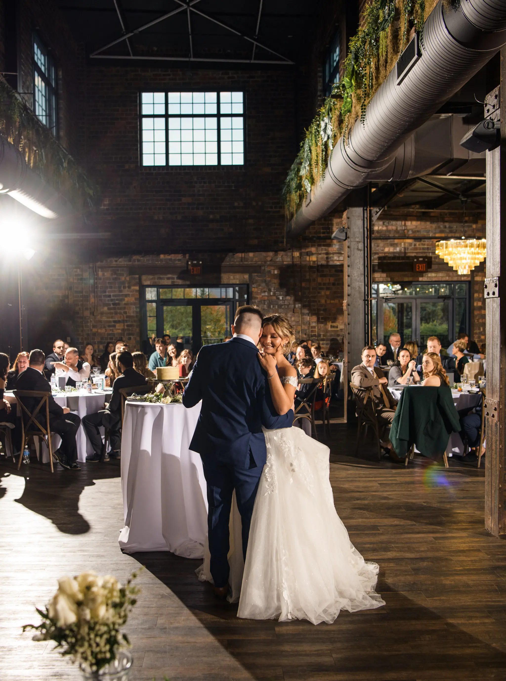 Bride wearing Harlem wedding dress by Maggie Sottero dancing with her husband
