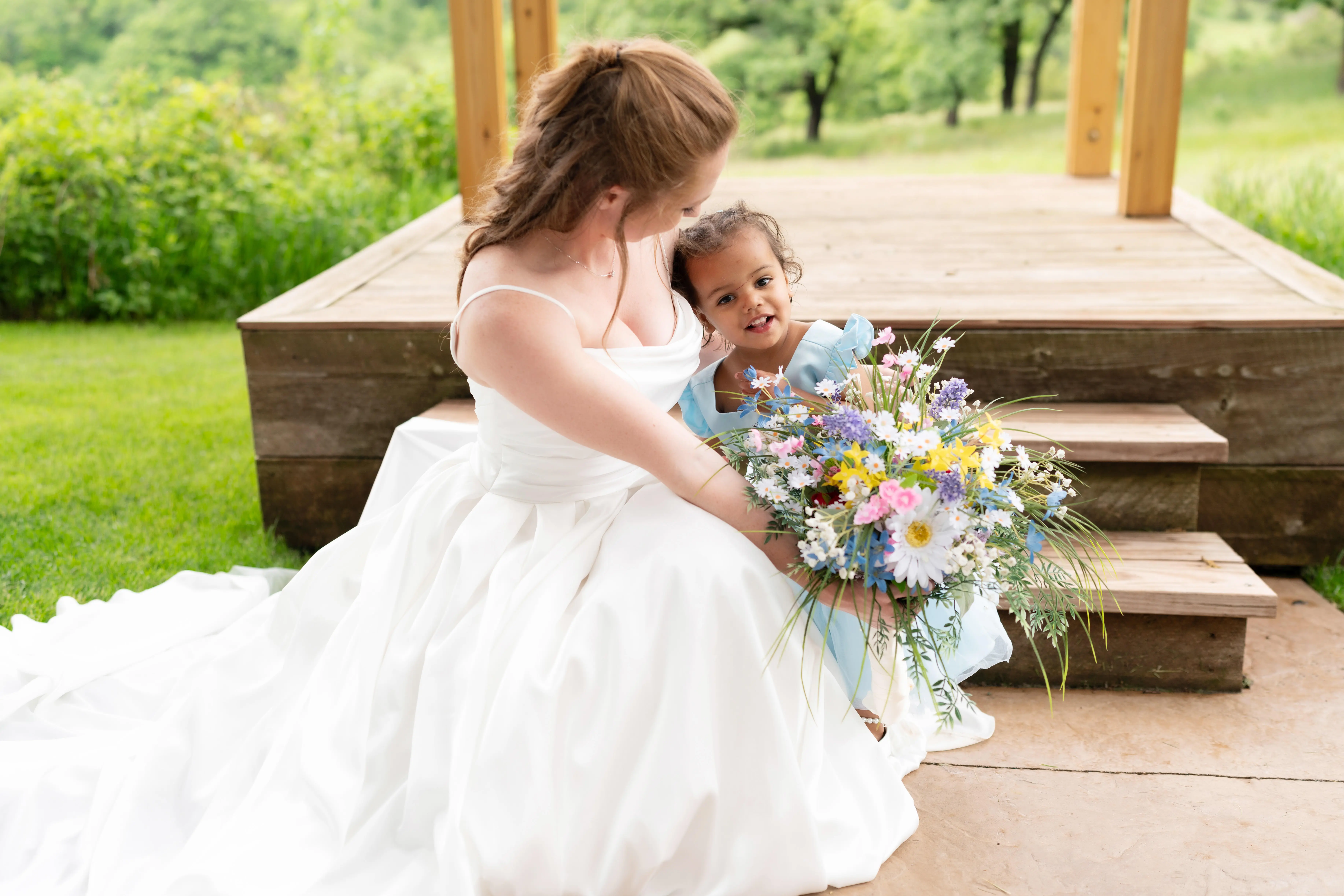 Bride wearing Scarlet by Maggie Sottero with a little girl