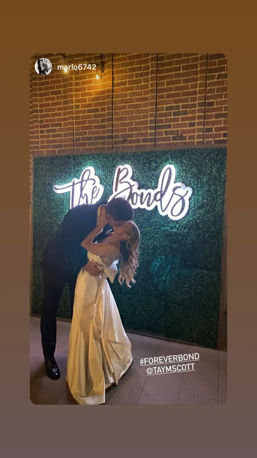 Bride with groom wearing unique strapless wedding dress