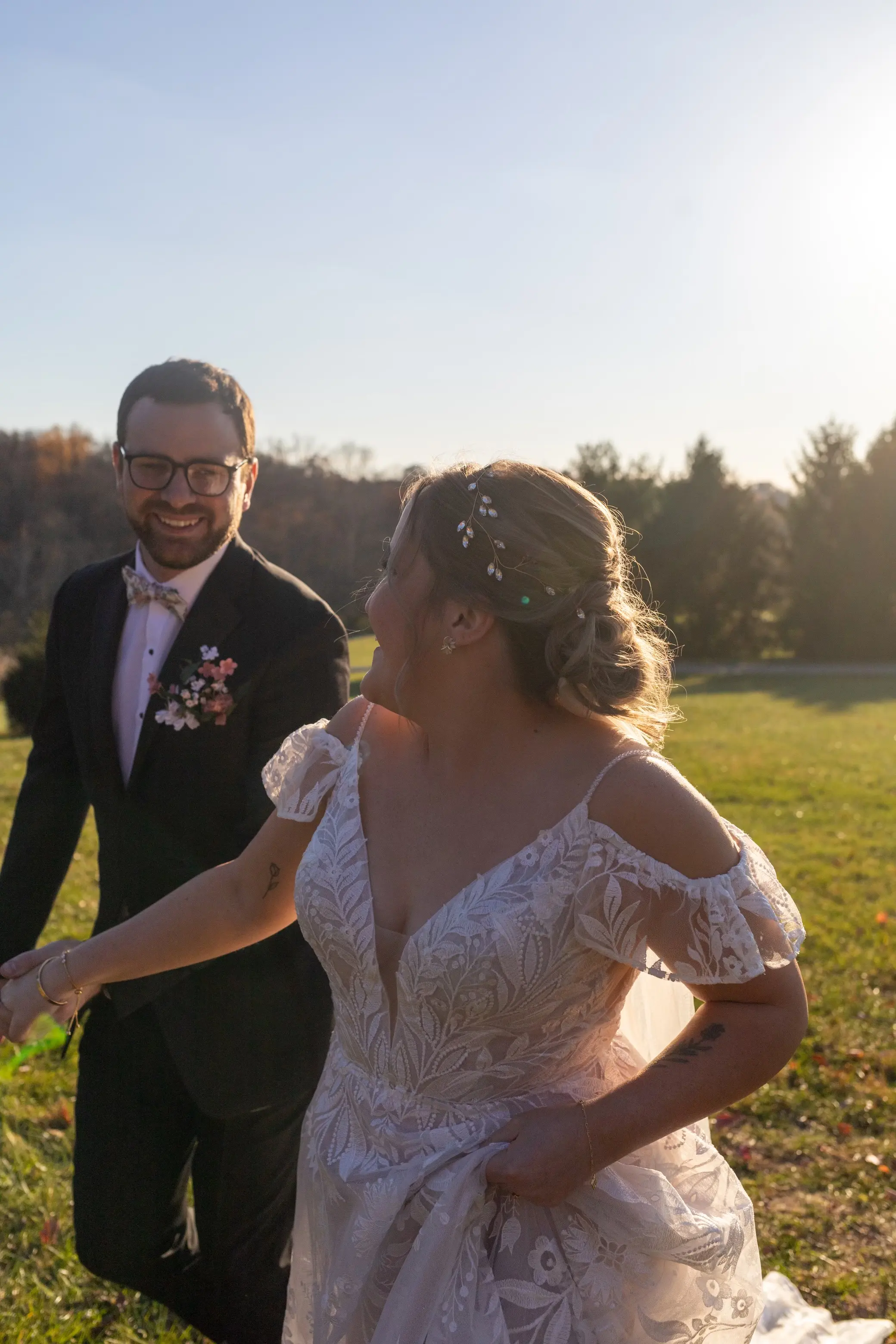 Bride wearing Keisha wedding dress by Maggie Sottero running with her husband