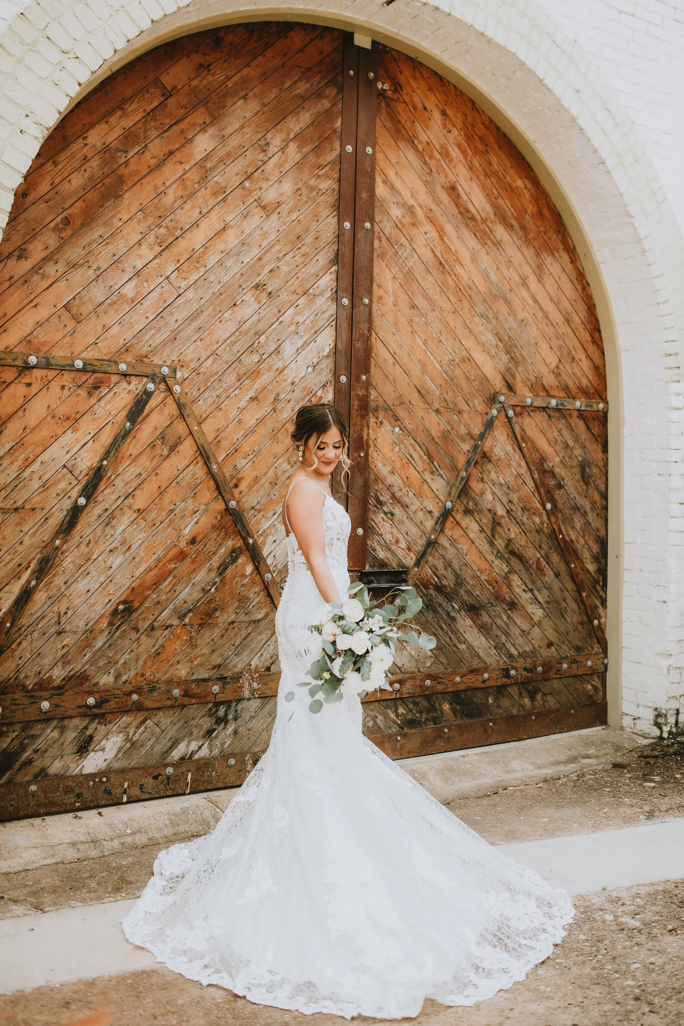 Bride in romantic lace sheath wedding dress