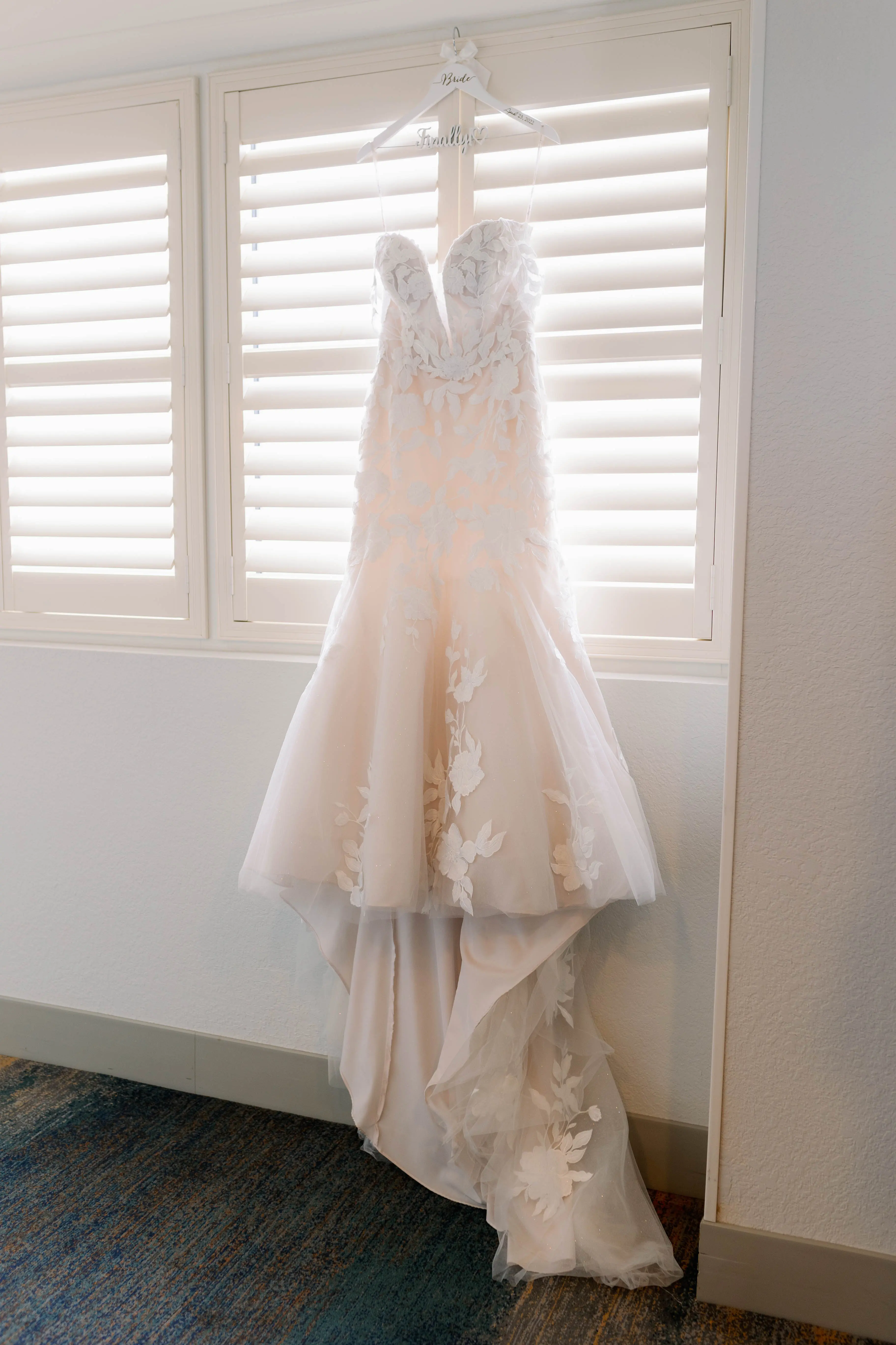 Lace Mermaid Wedding Gown Called Hattie By Rebecca Ingram Hanging From A Window