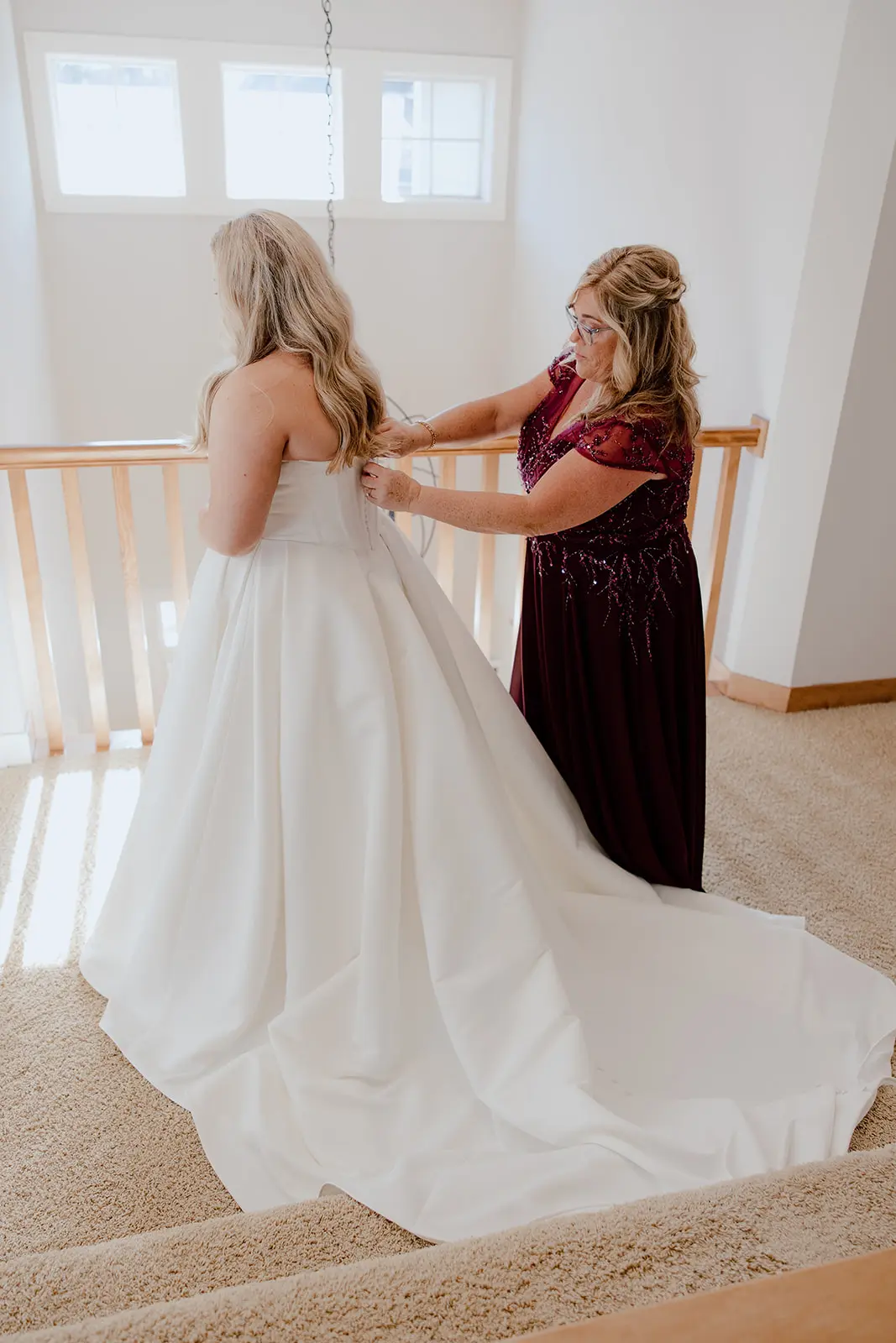 Bride wearing Derrick by Maggie Sottero being zipped up