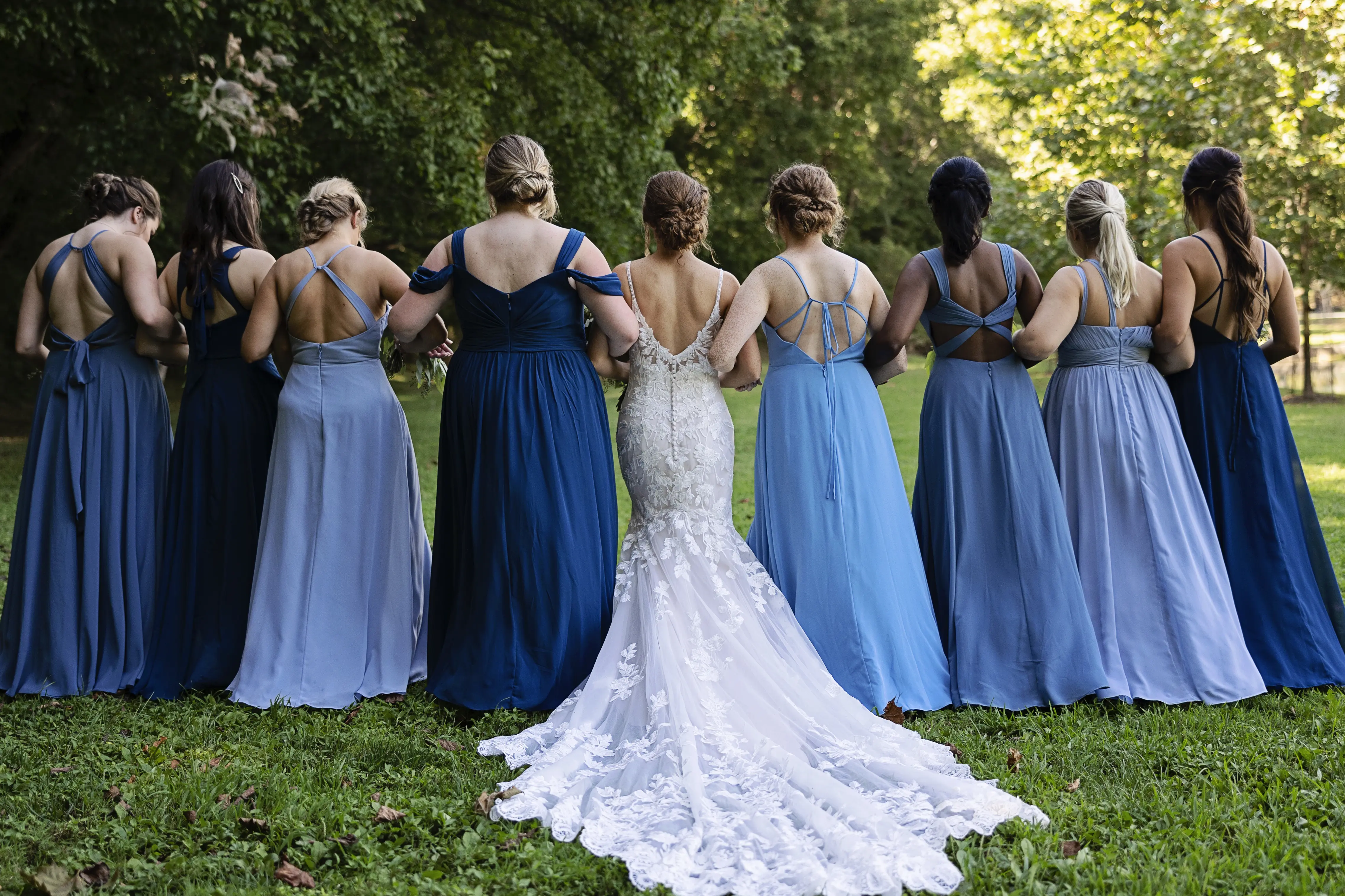 Bride In Sexy Lace Wedding Dress Called Giana By Maggie Sottero With Bridesmaids In Blue