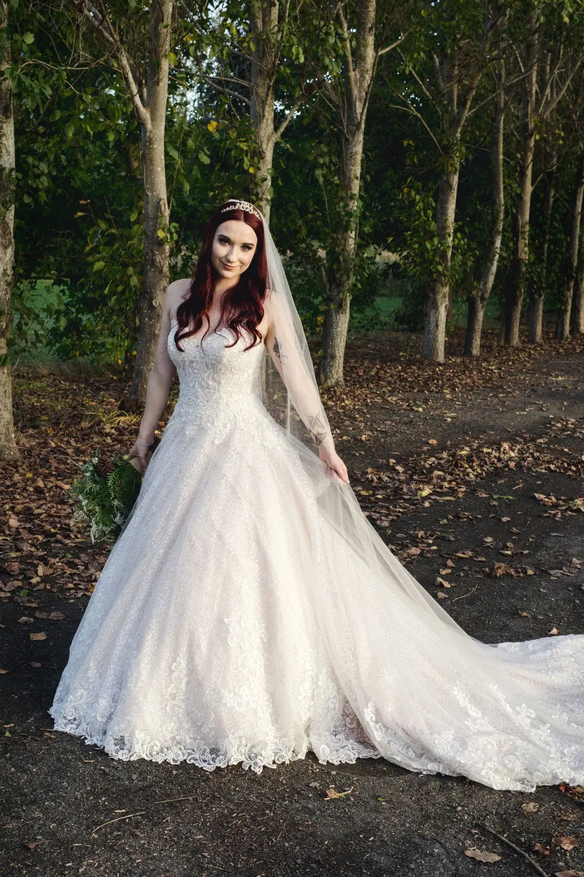 Bride in Lace Ball Gown Wedding Dress with Sequined Tulle and Lace Motifs over Bodice and Statement Hemline called Tristyn by Maggie Sottero
