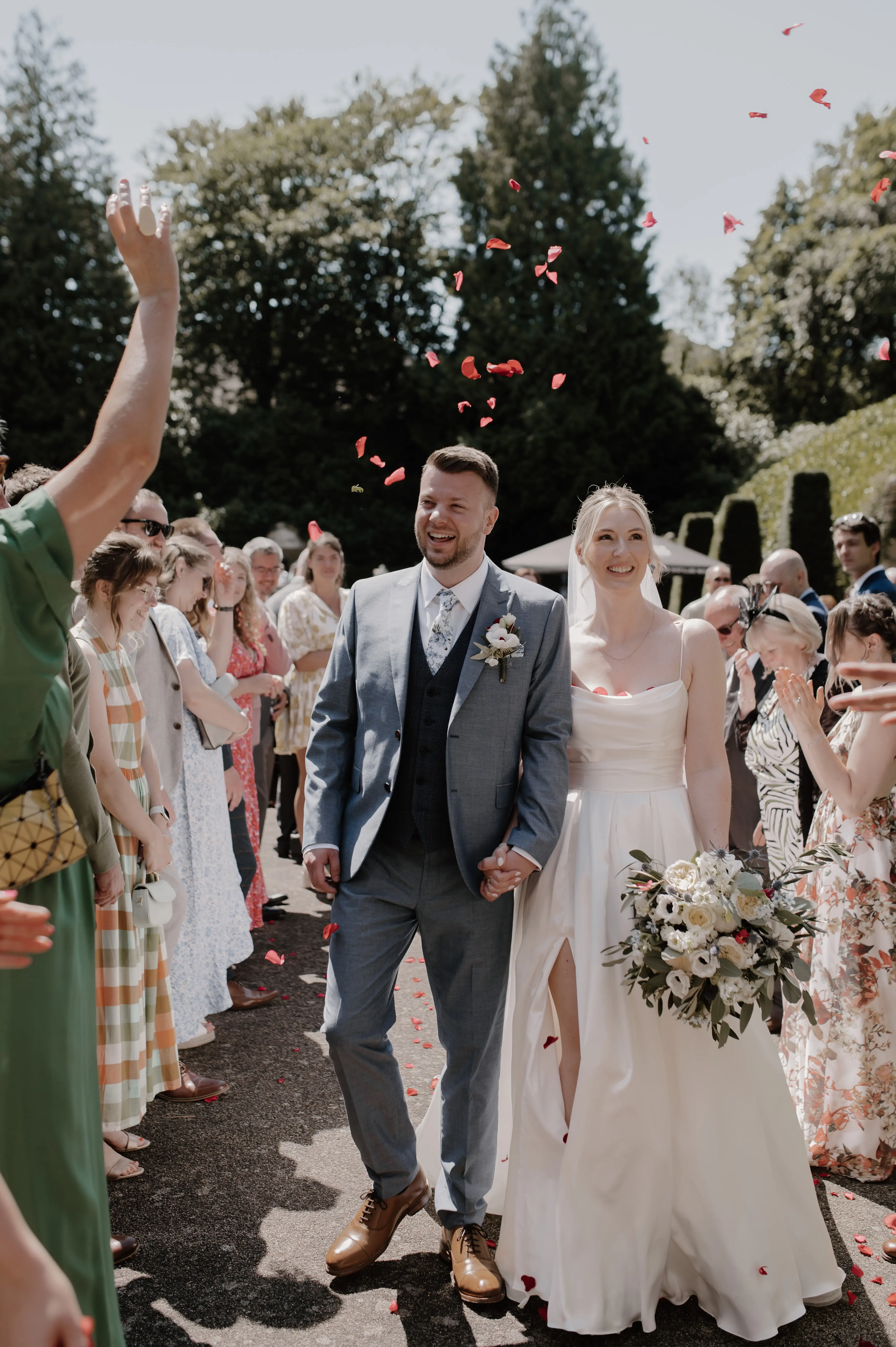 Bride wearing Scarlet by Maggie Sottero and her husband exiting their wedding