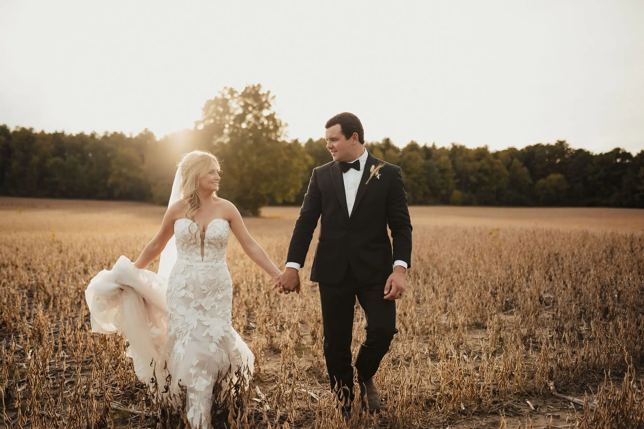 Bride in mermaid style wedding dress called Hattie by Rebecca Ingram with groom in nature