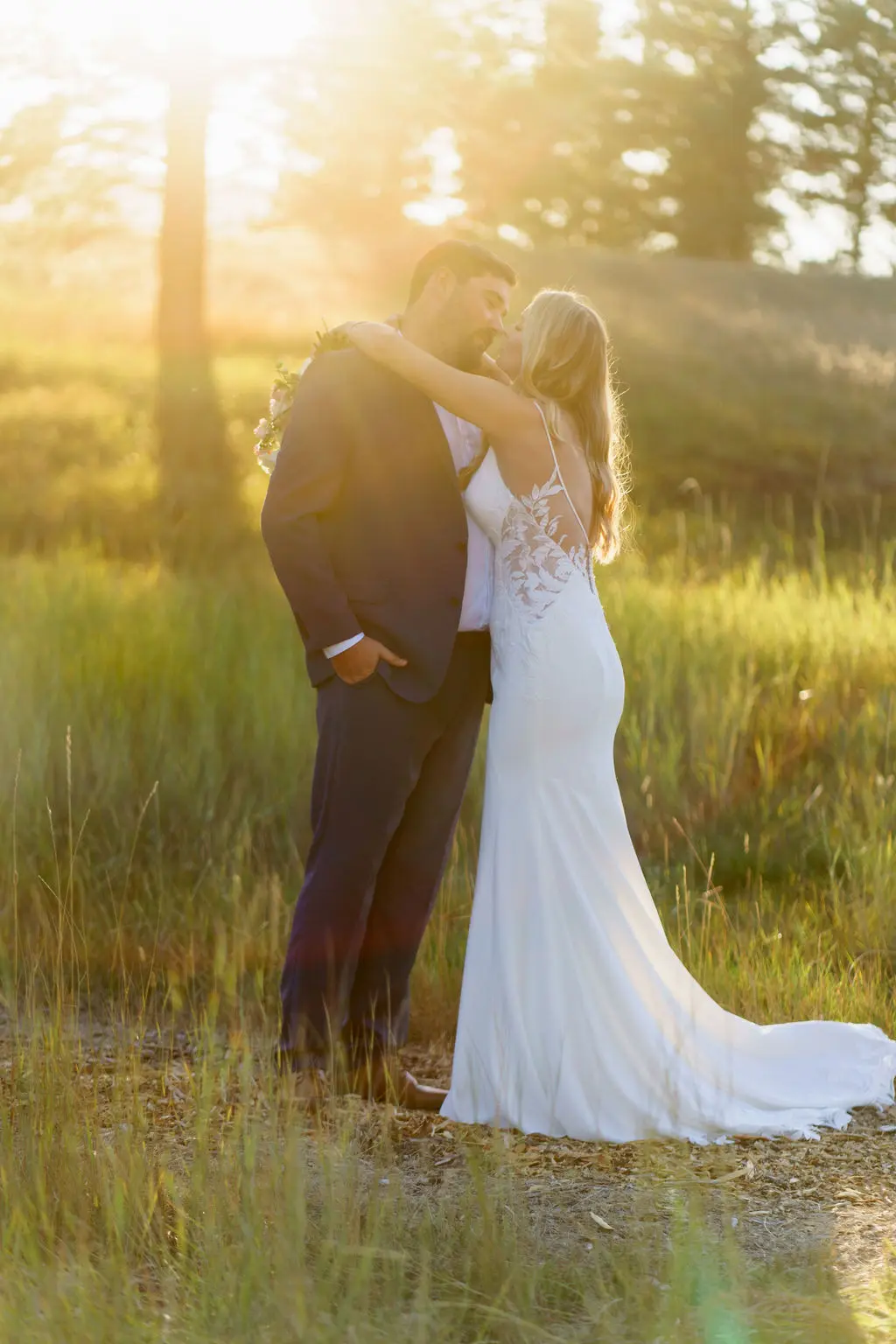 Bride wearing Dionne wedding dress by Rebecca Ingram hugging her husband