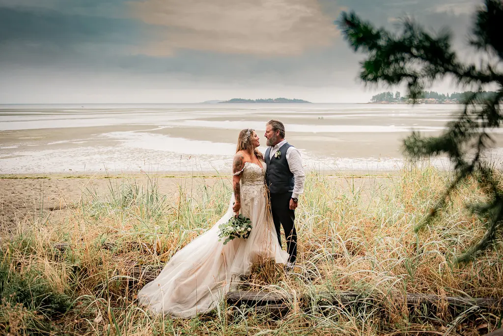 Bride wearing Boho Wedding Dress called Stevie by Maggie Sottero on the beach with her groom