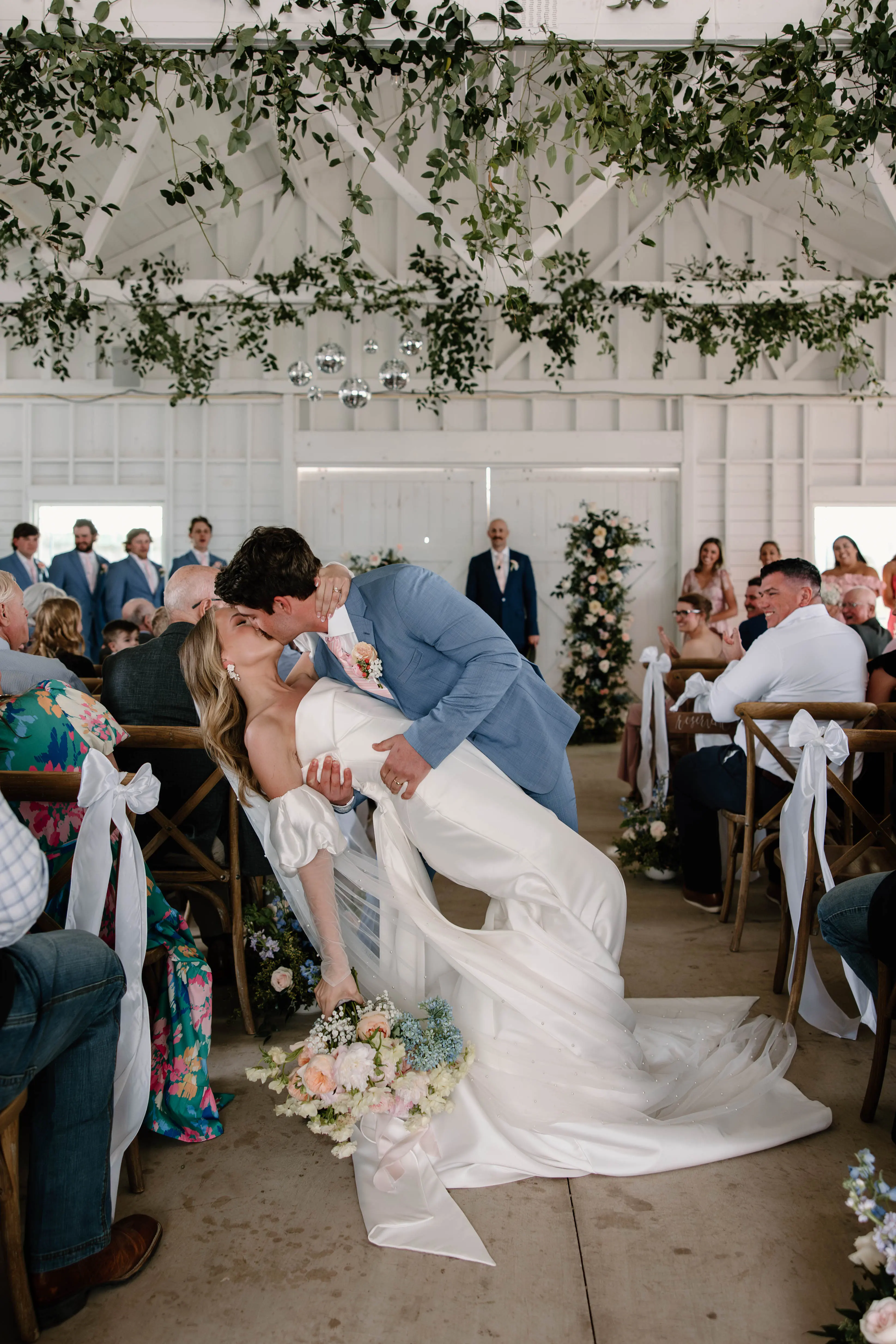 Bride wearing Mitchell by Maggie Sottero kissing her husband