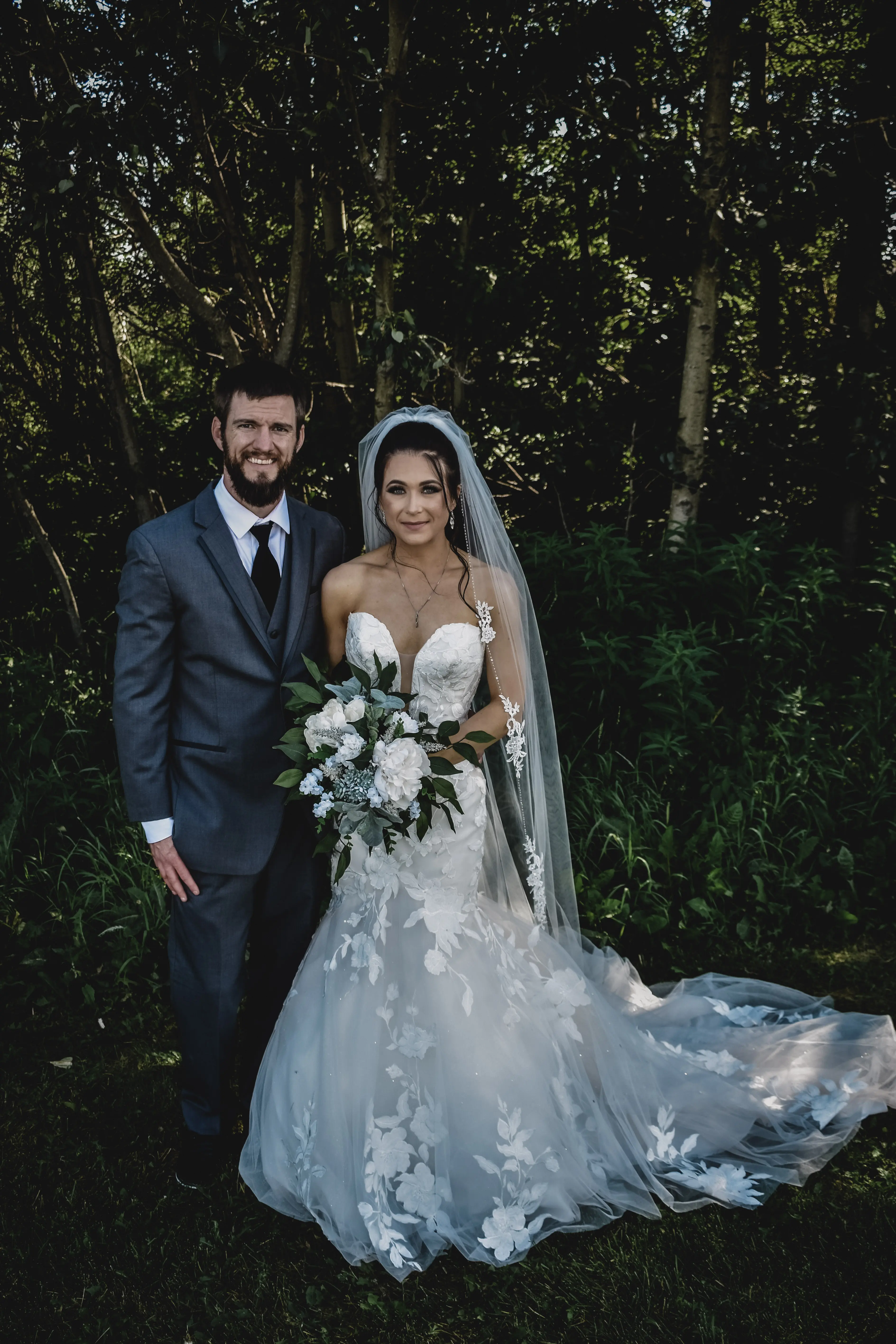 Bride Wearing Lace Mermaid Wedding Dress Called Hattie By Rebecca Ingram With Groom In The Forest