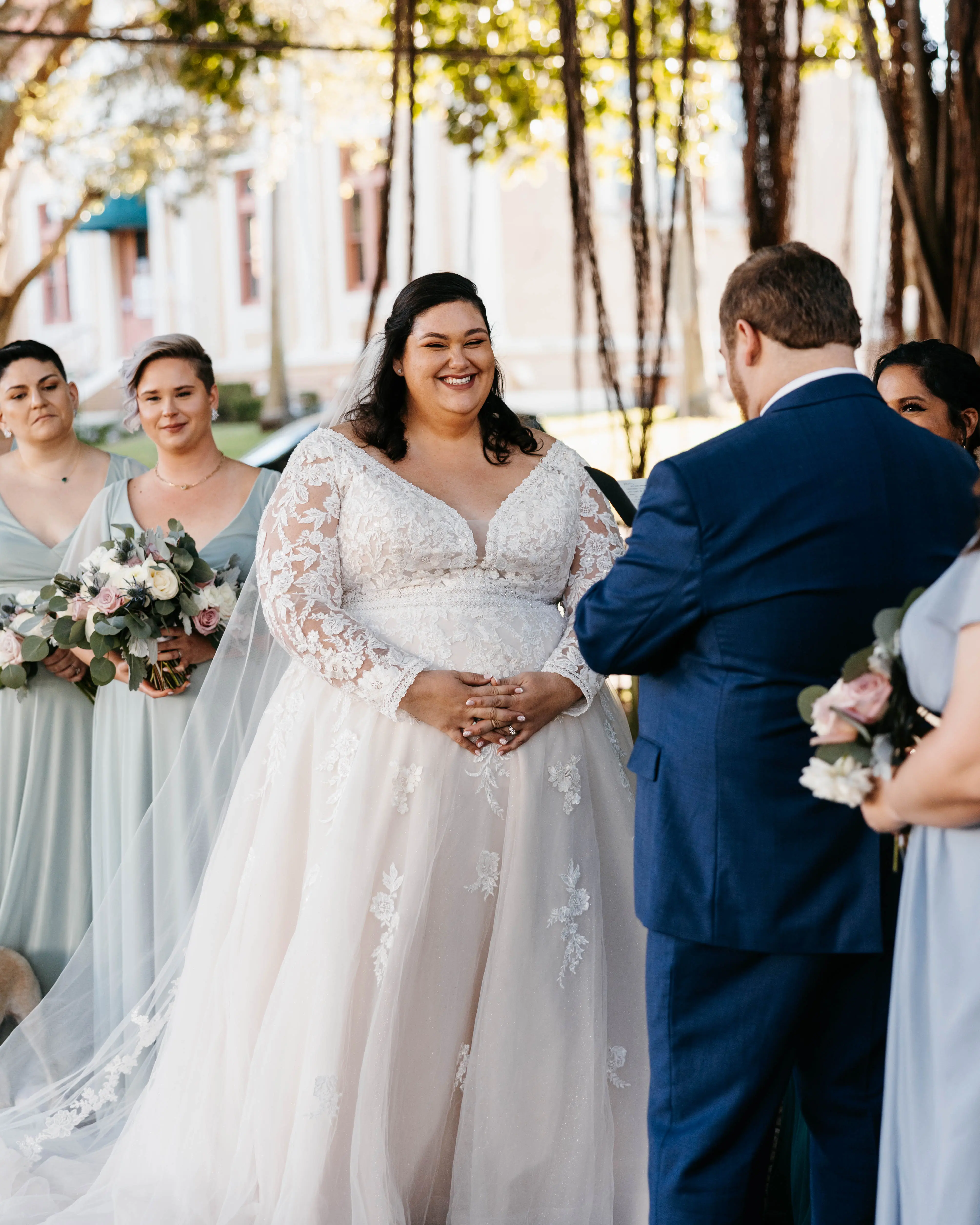 Groom With Bride Wearing Illusion Sleeve A-Line Wedding Dress Raphael By Maggie Sottero