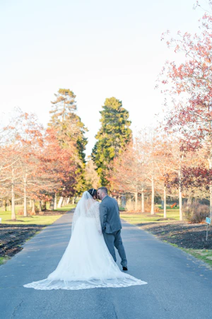Bride And Groom Together. Bride Wearing Long Sleeve Lace Ball Gown With Tulle Skirt Called Mallory Dawn By Maggie Sottero