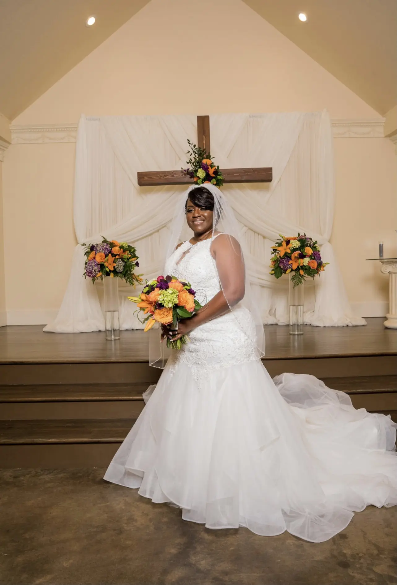 Bride with colorful bright bouquet in wedding dress called Veda.
