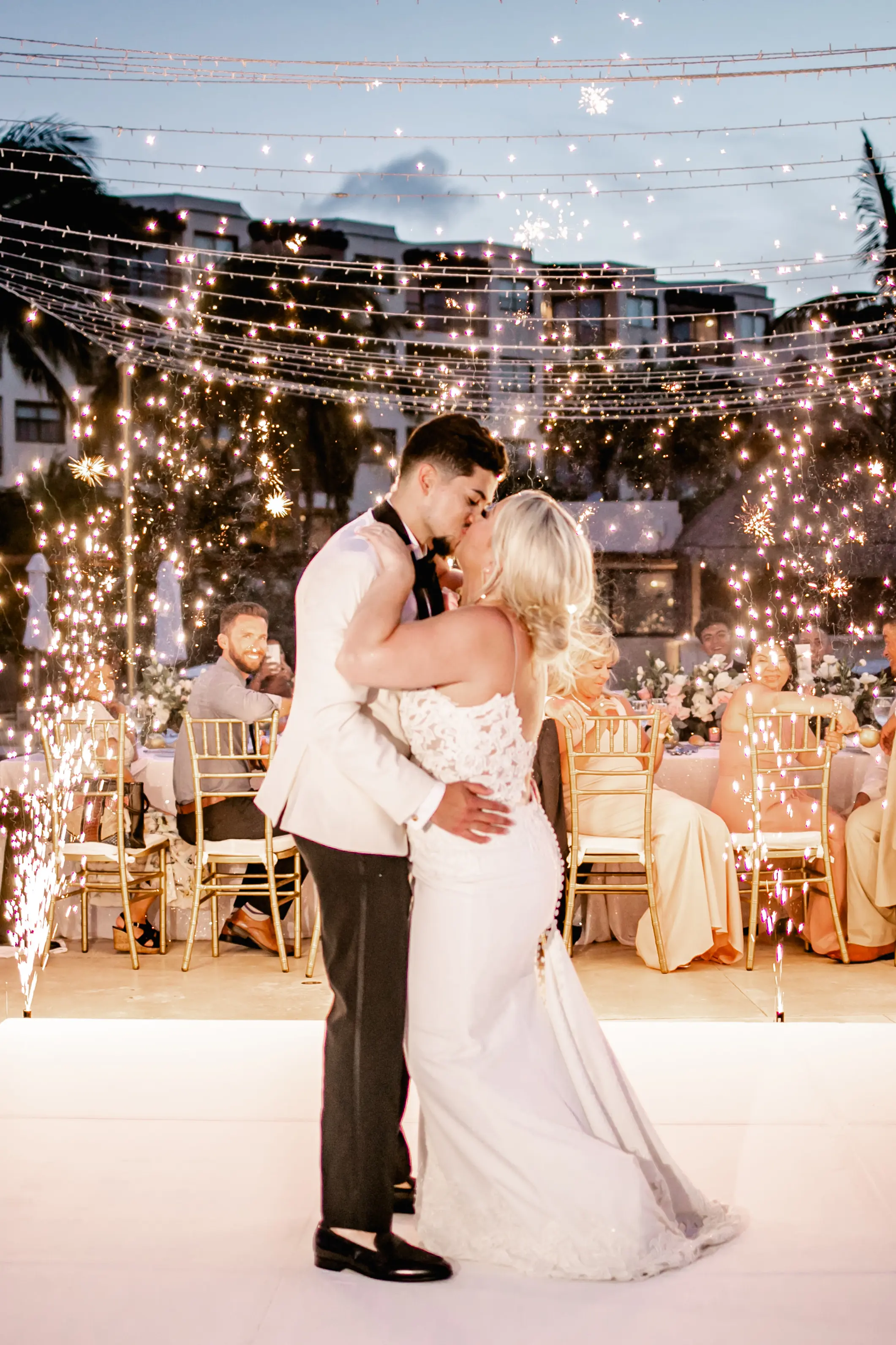 bride and groom kissing on dance floor.