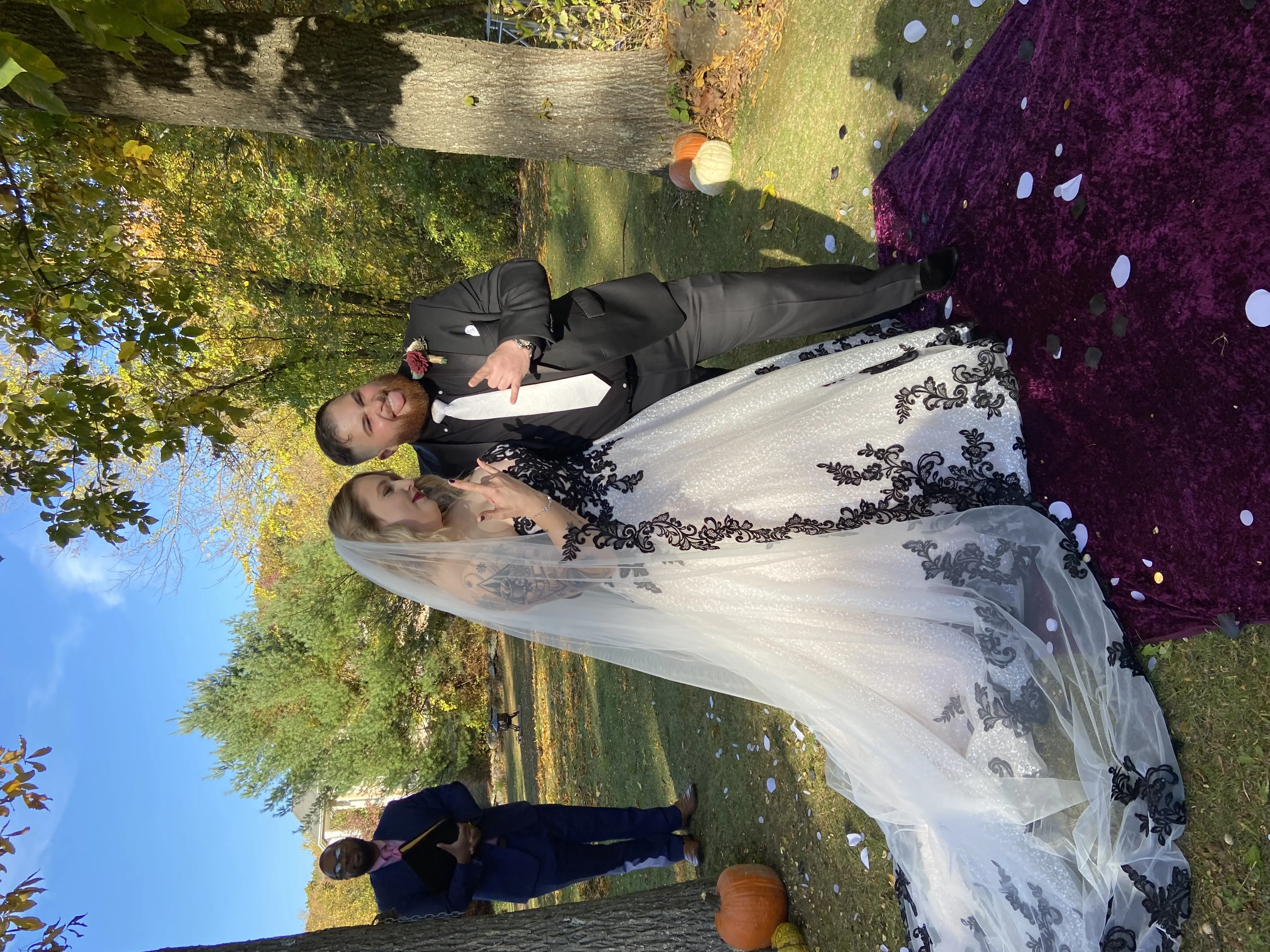 Bride Wearing Black Lace Wedding Dress Called Tristyn By Maggie Sottero With Groom Doing Rock On Sign