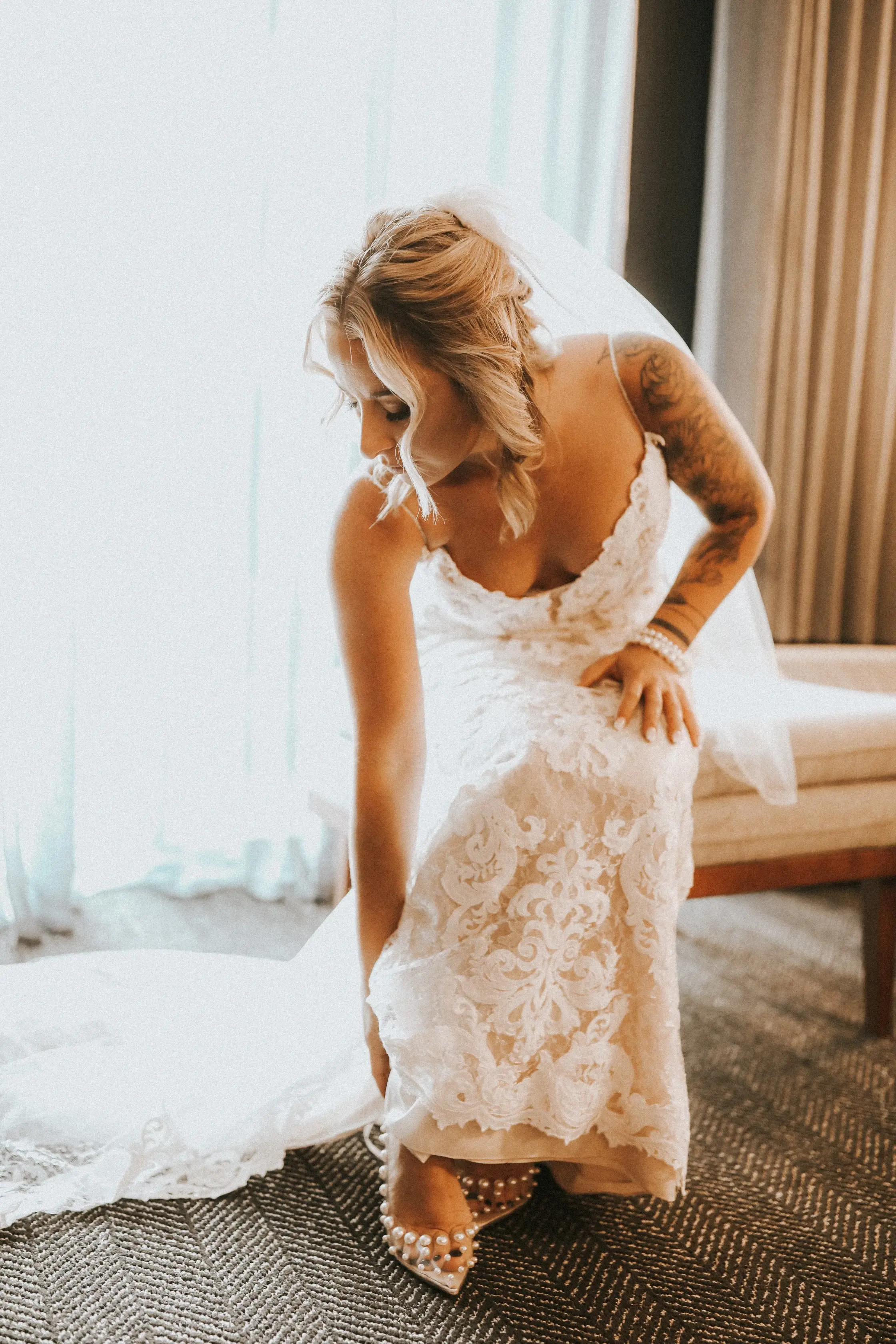 Bride In Lace Sheath Wedding Gown Name Tuscany Lynette By Maggie Sottero Bride Putting On Shoes