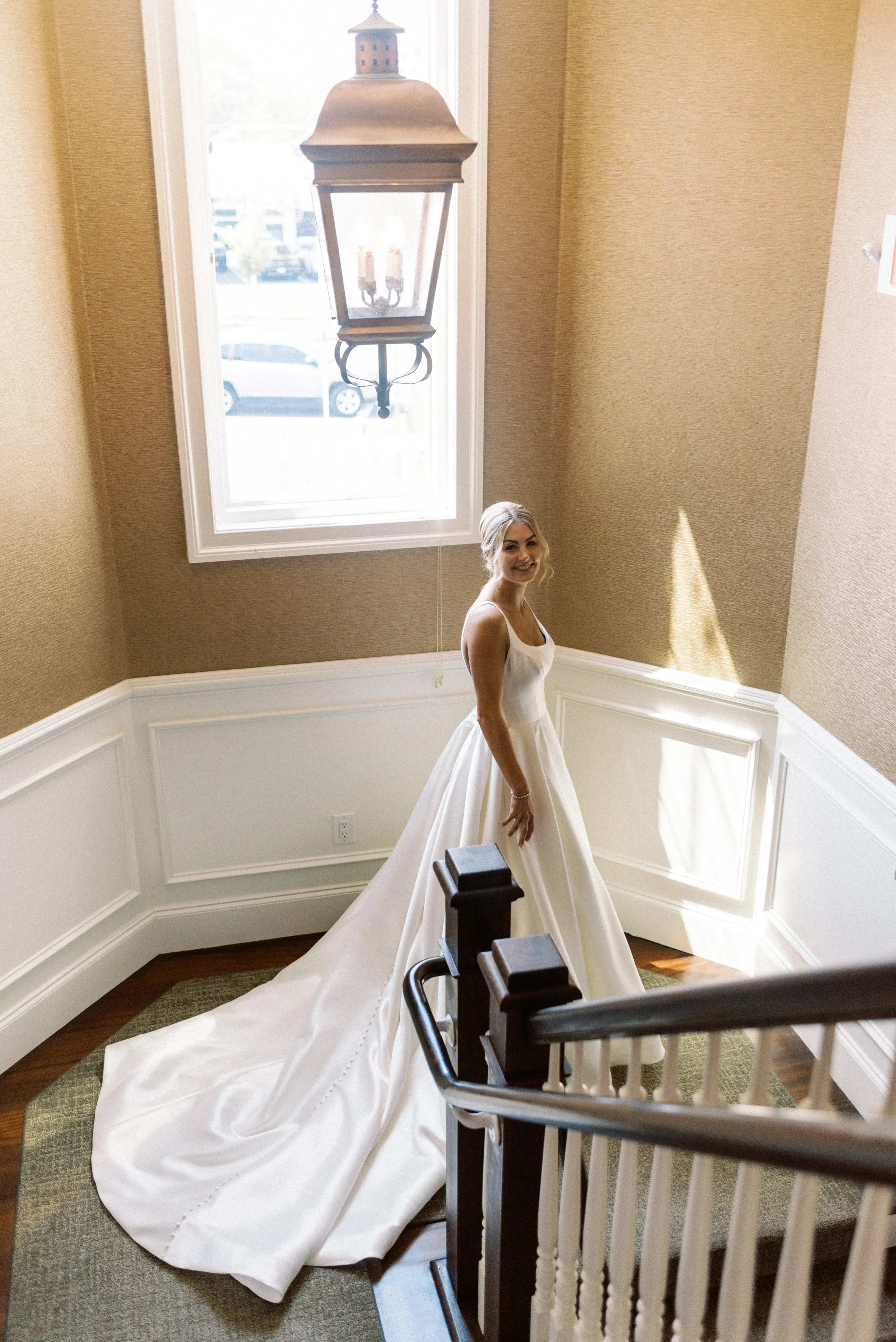 Bride wearing Selena wedding dress by Maggie Sottero on the stairs