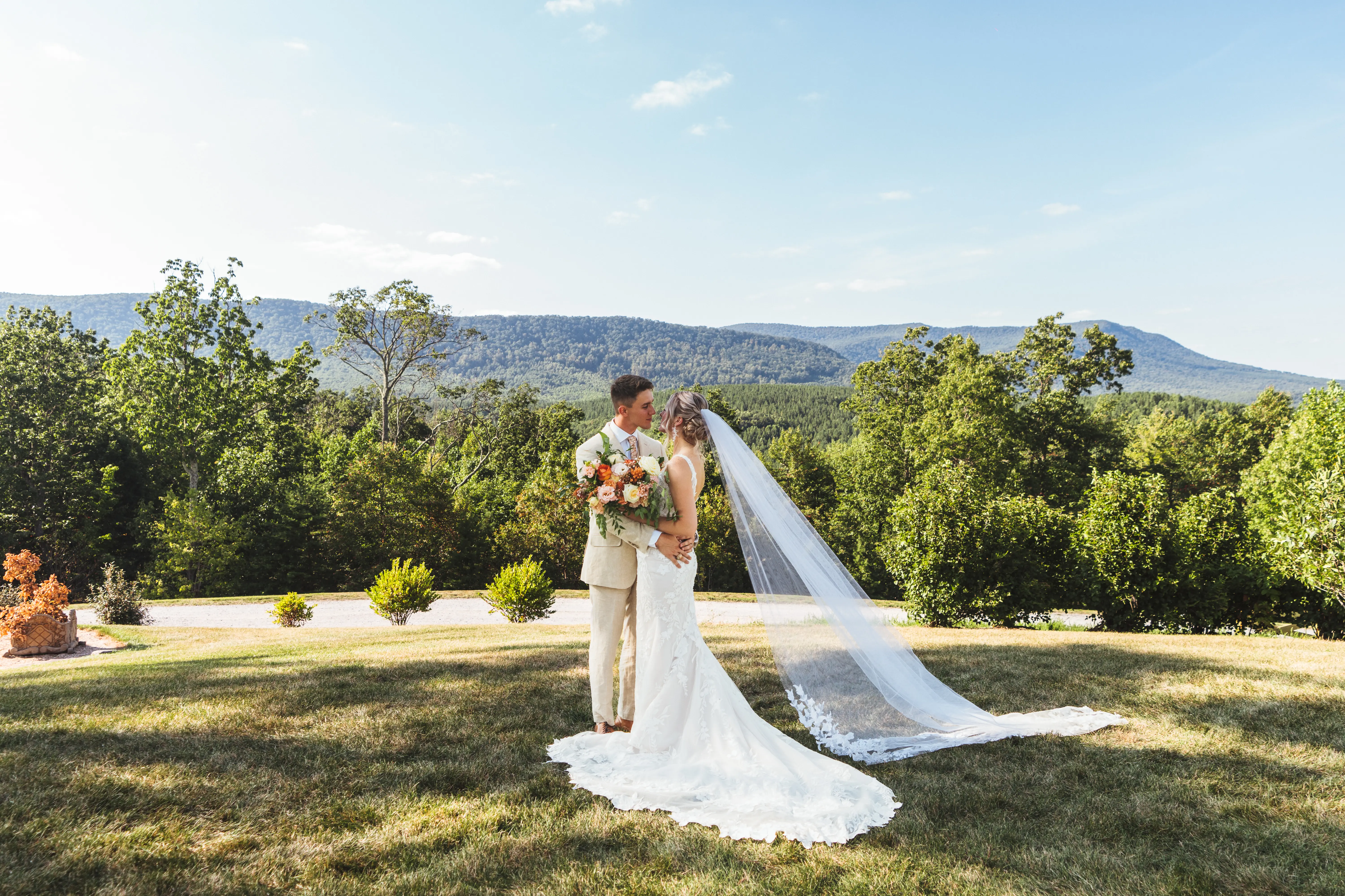 Bride wearing Albany wedding dress by Maggie Sottero standing with her husband