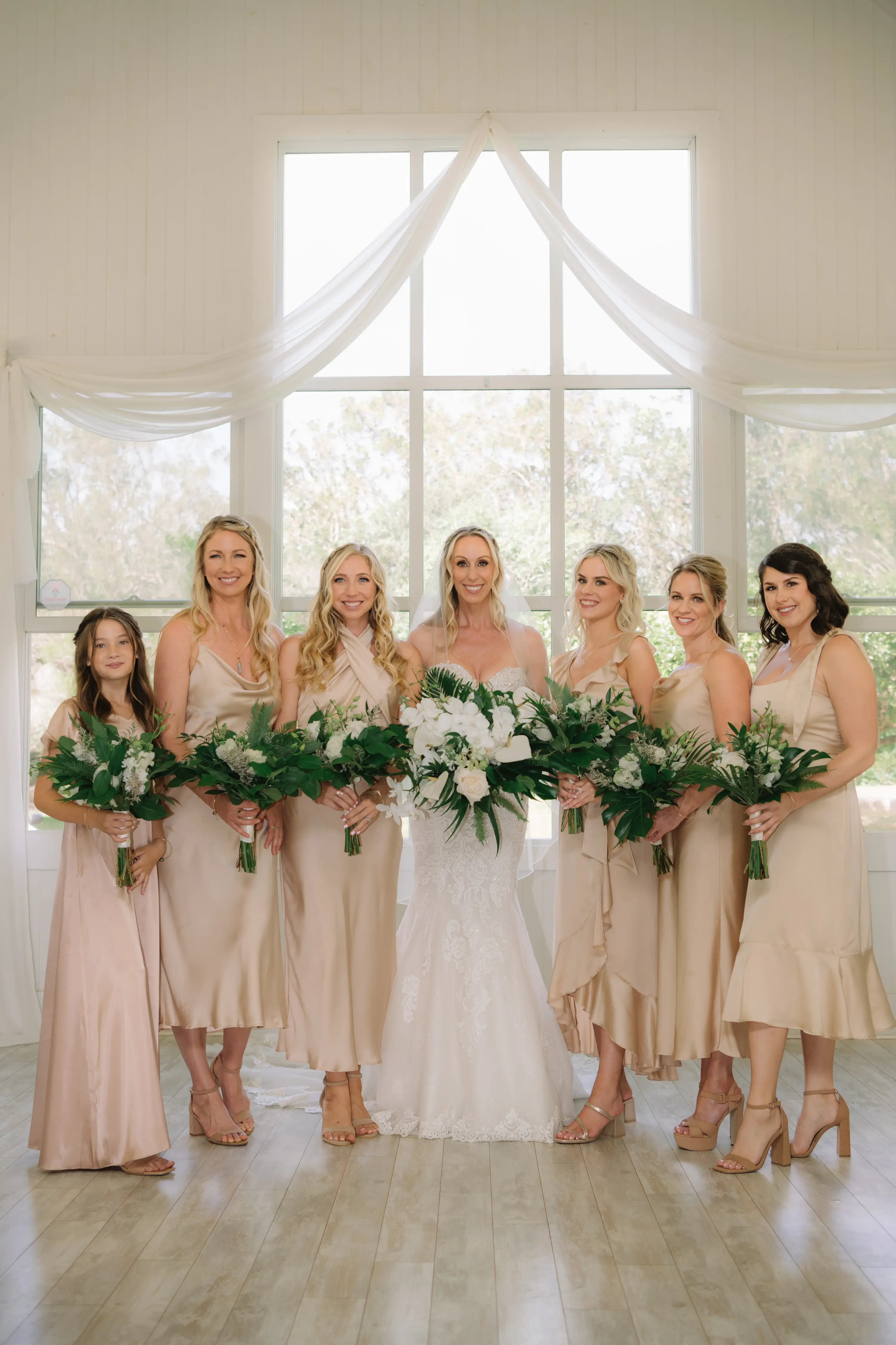 Bride In Beach Fit-And-Flare Wedding Dress Called Fiona By Maggie Sottero With Bridesmaids In Neutral