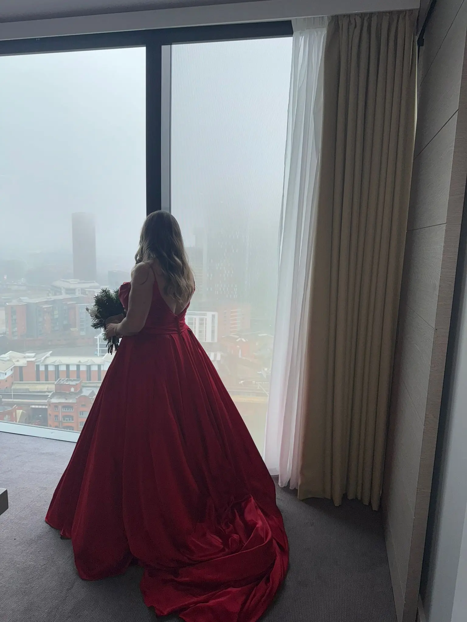 Bride Wearing Red Aline Wedding Dress Called Scarlet By Maggie Sottero Looking Out A Window