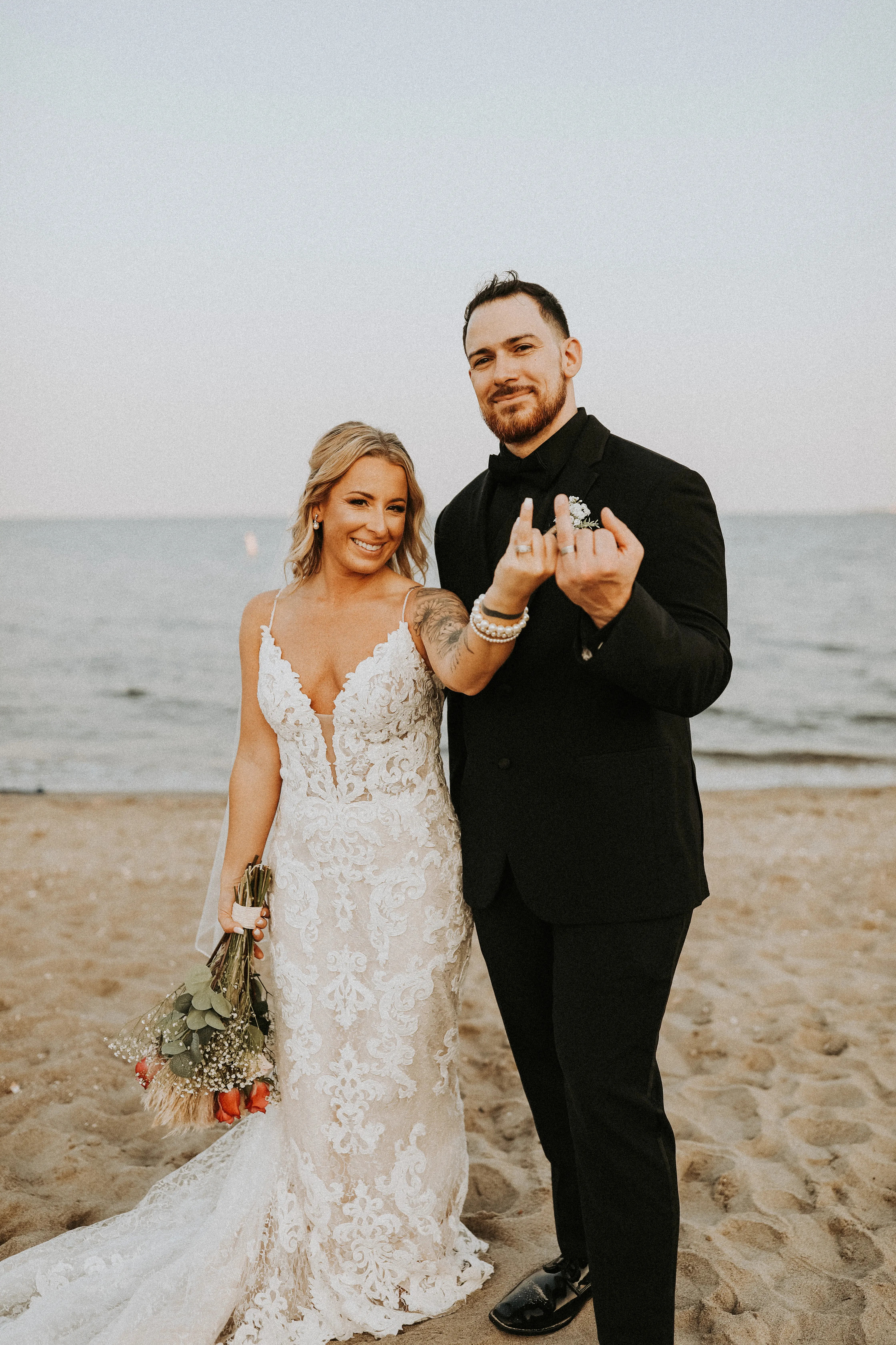 Bride In Lace Sheath Wedding Gown Name Tuscany Lynette By Maggie Sottero Bride And Groom Showing Rings