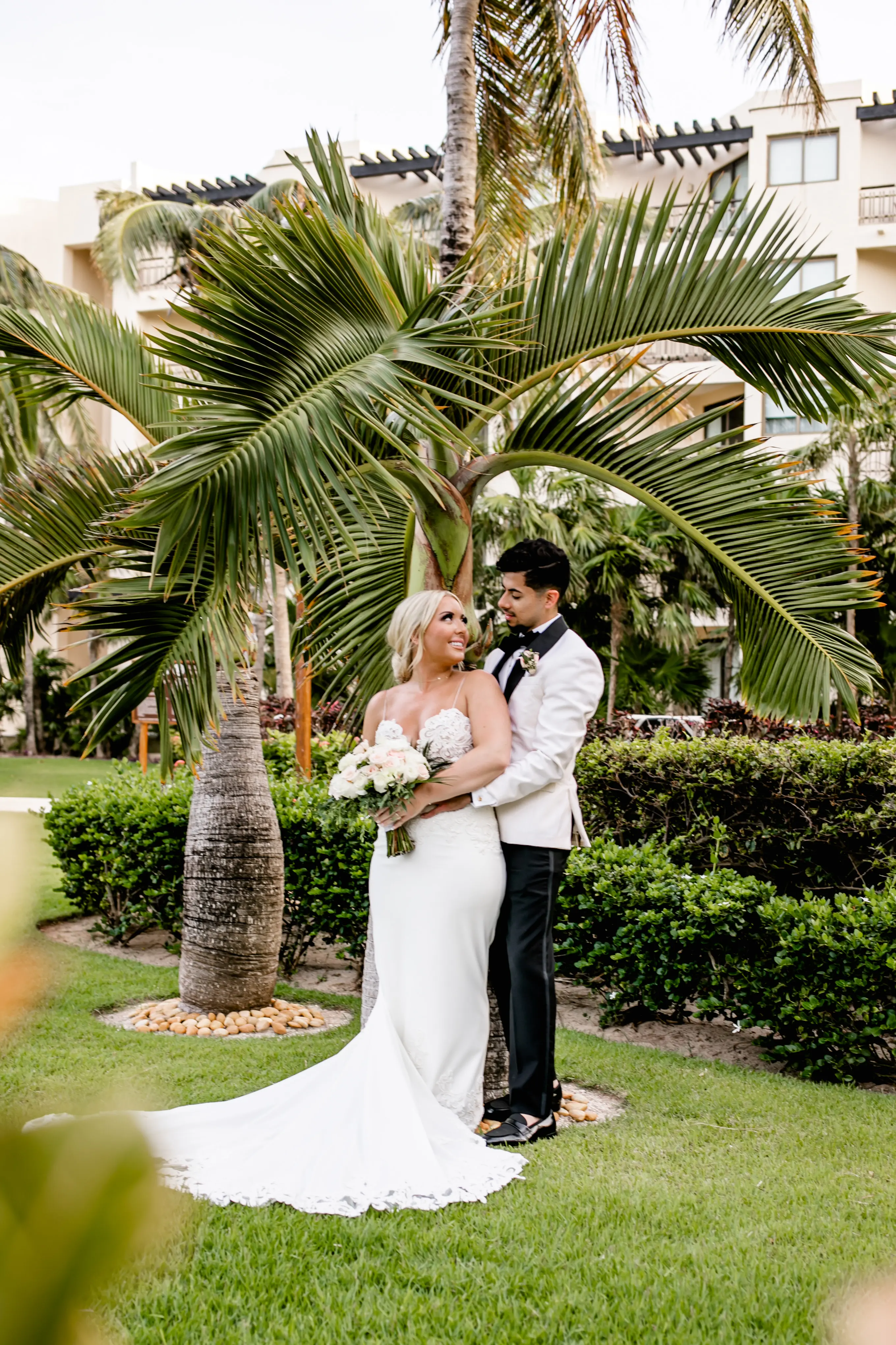 bride and groom looking at each other smiling.