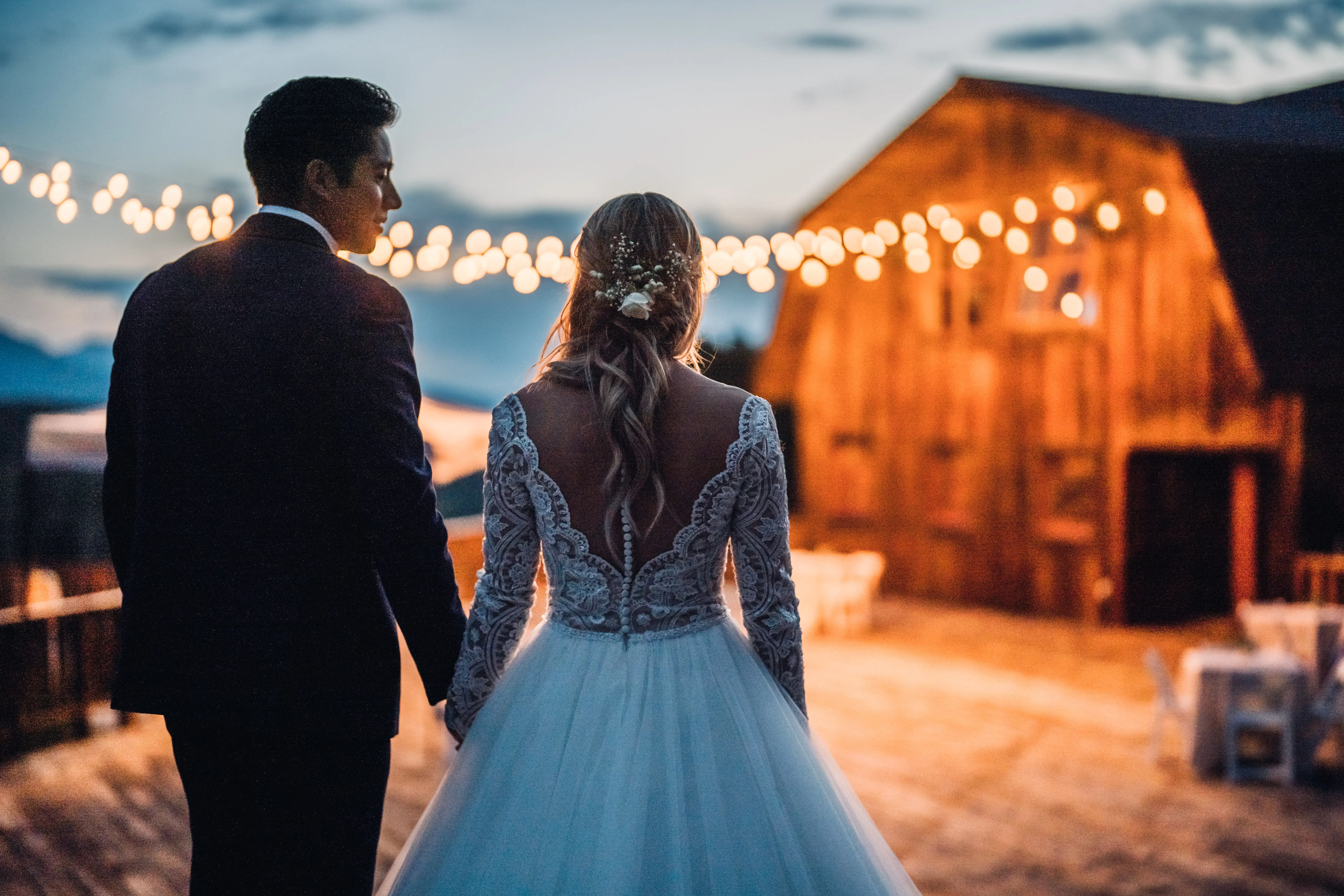 Bride with groom wearing long sleeve lace ballgown wedding dress