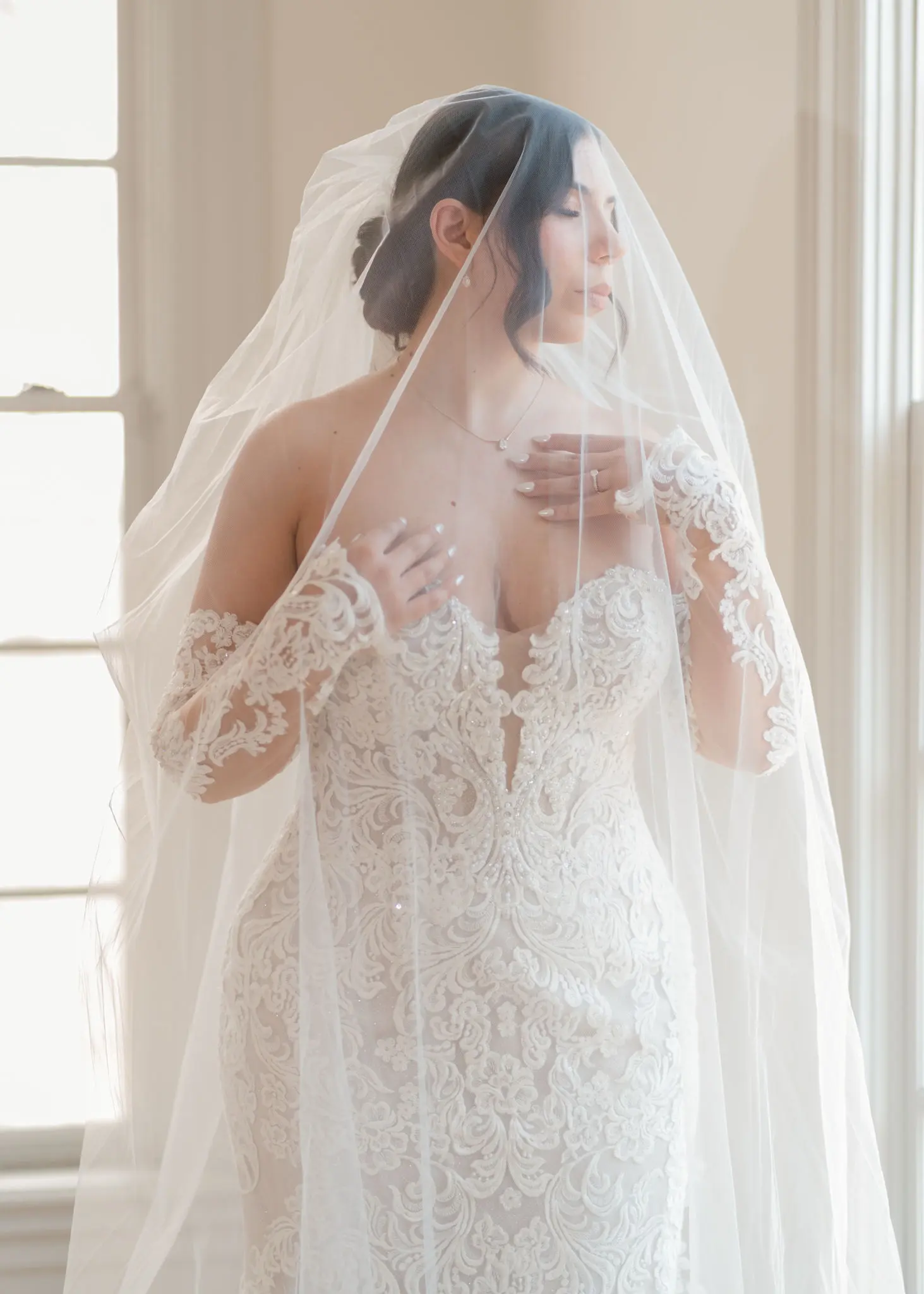 Bride wearing Fiona wedding dress by Maggie Sottero with a veil