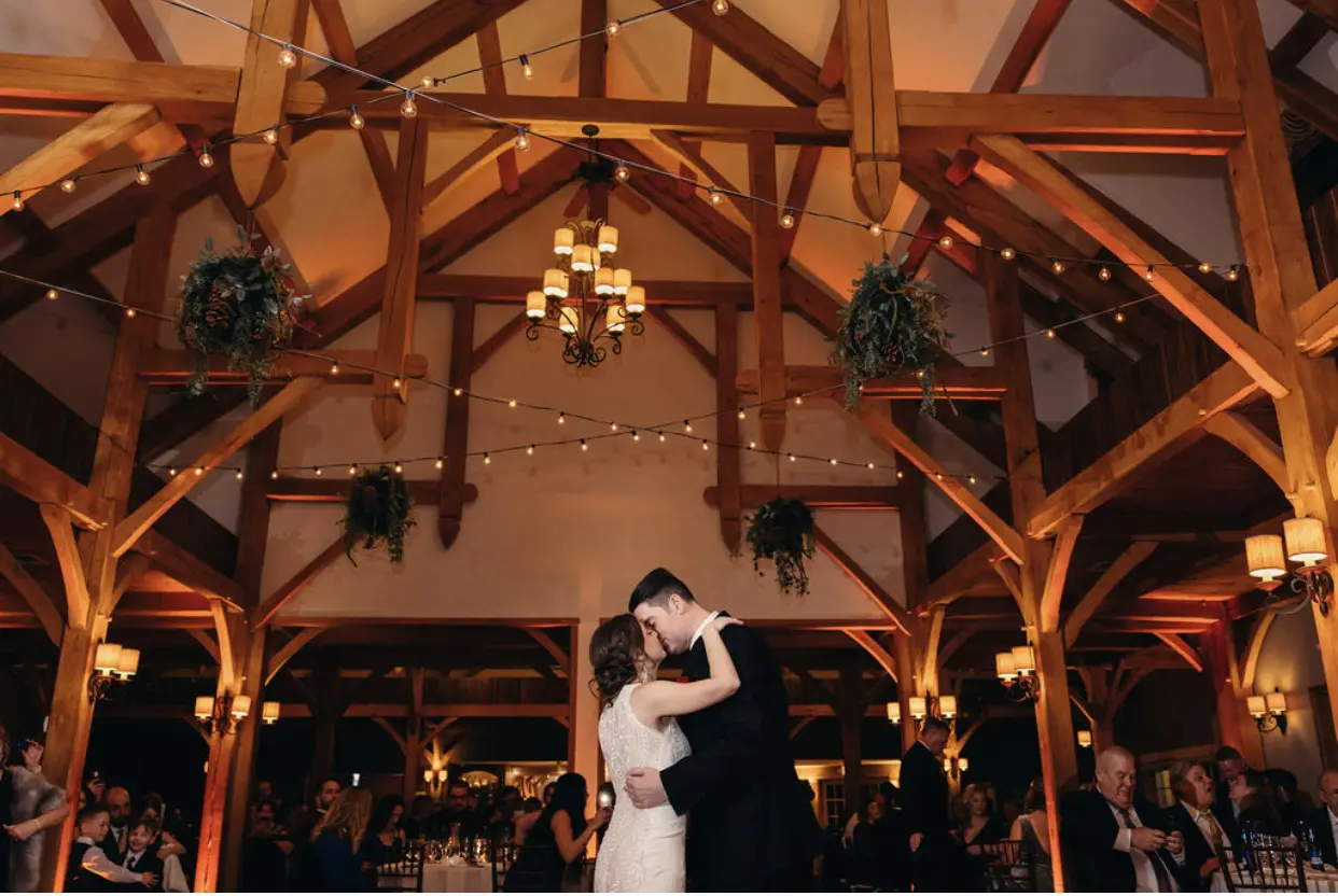Bride Wearing Lace Halter Wedding Gown Called Kevyn By Sottero And Midgley Kissing The Groom