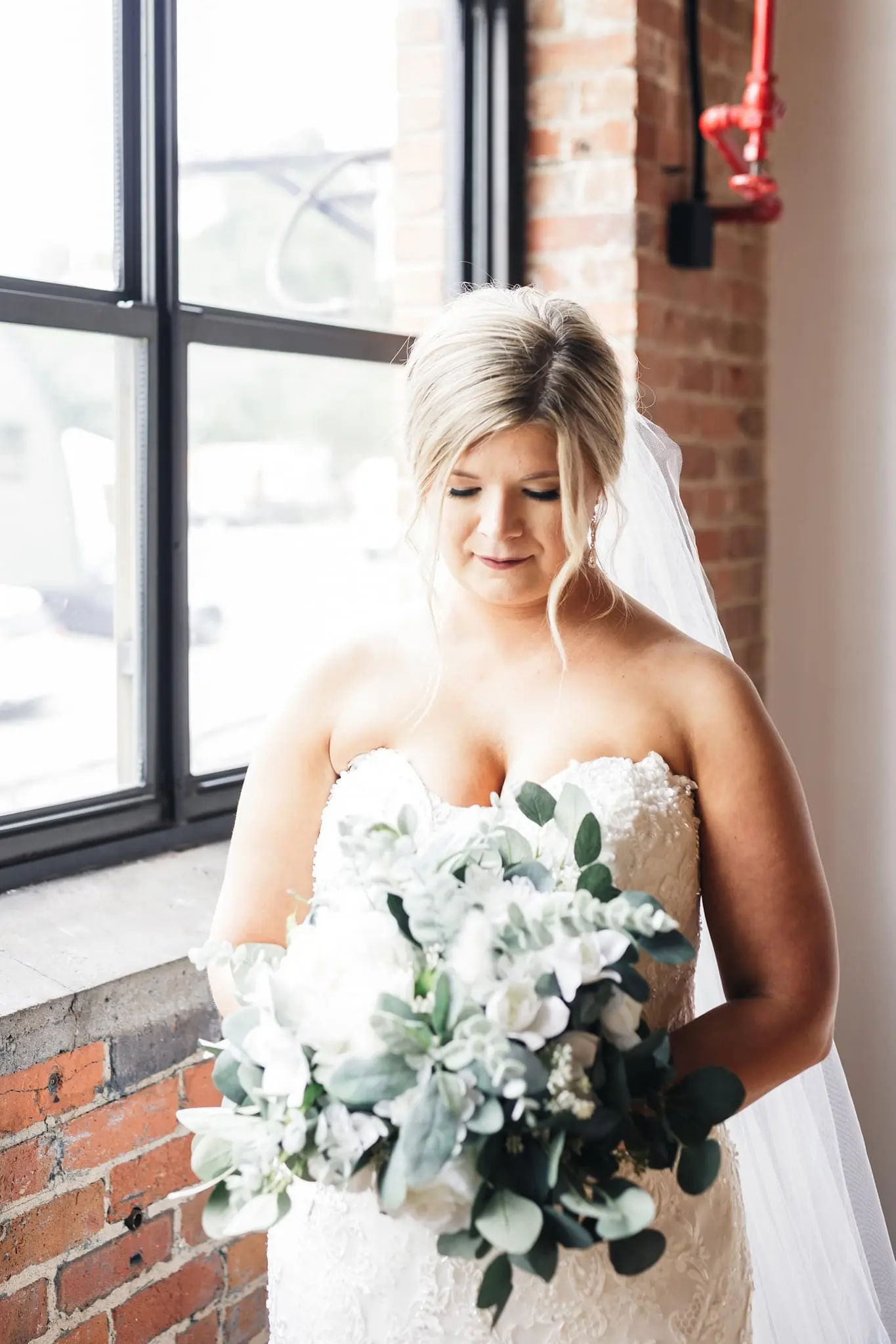 Bride wearing glamorous plus size mermaid wedding dress