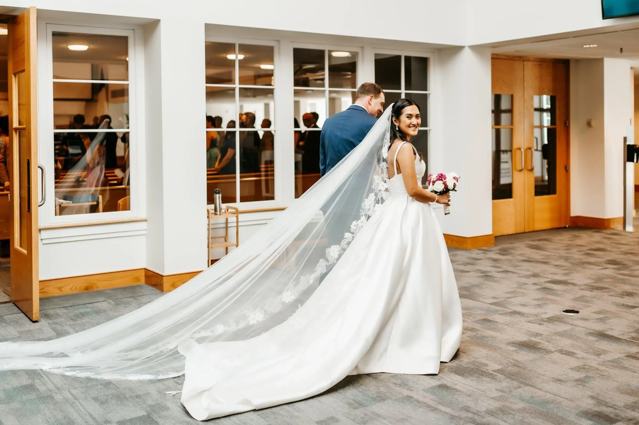 Bride Wearing Sleek Ball Gown Wedding Dress Walking With Husband