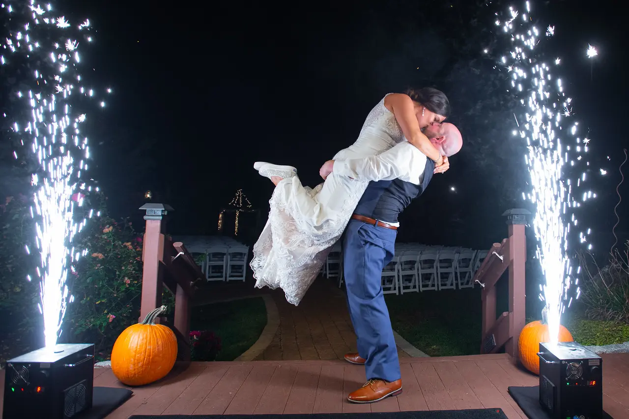 Bride wearing Lace Sheath Wedding Dress called Kevyn by Sottero and Midgley with groom with sparklers
