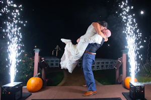 Bride wearing Lace Sheath Wedding Dress called Kevyn by Sottero and Midgley with groom with sparklers