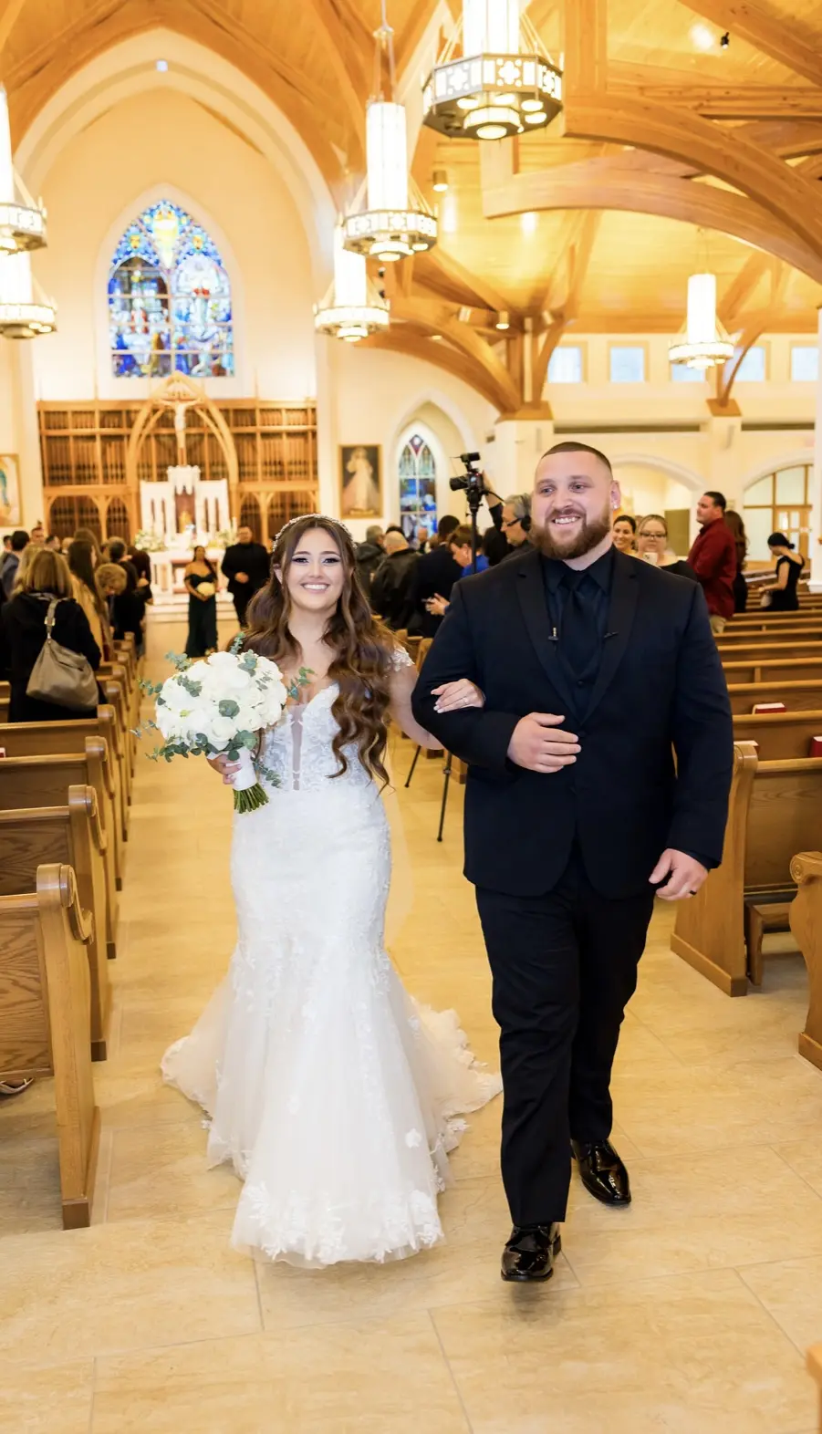 Bride wearing Lennon wedding dress by Maggie Sottero in a church