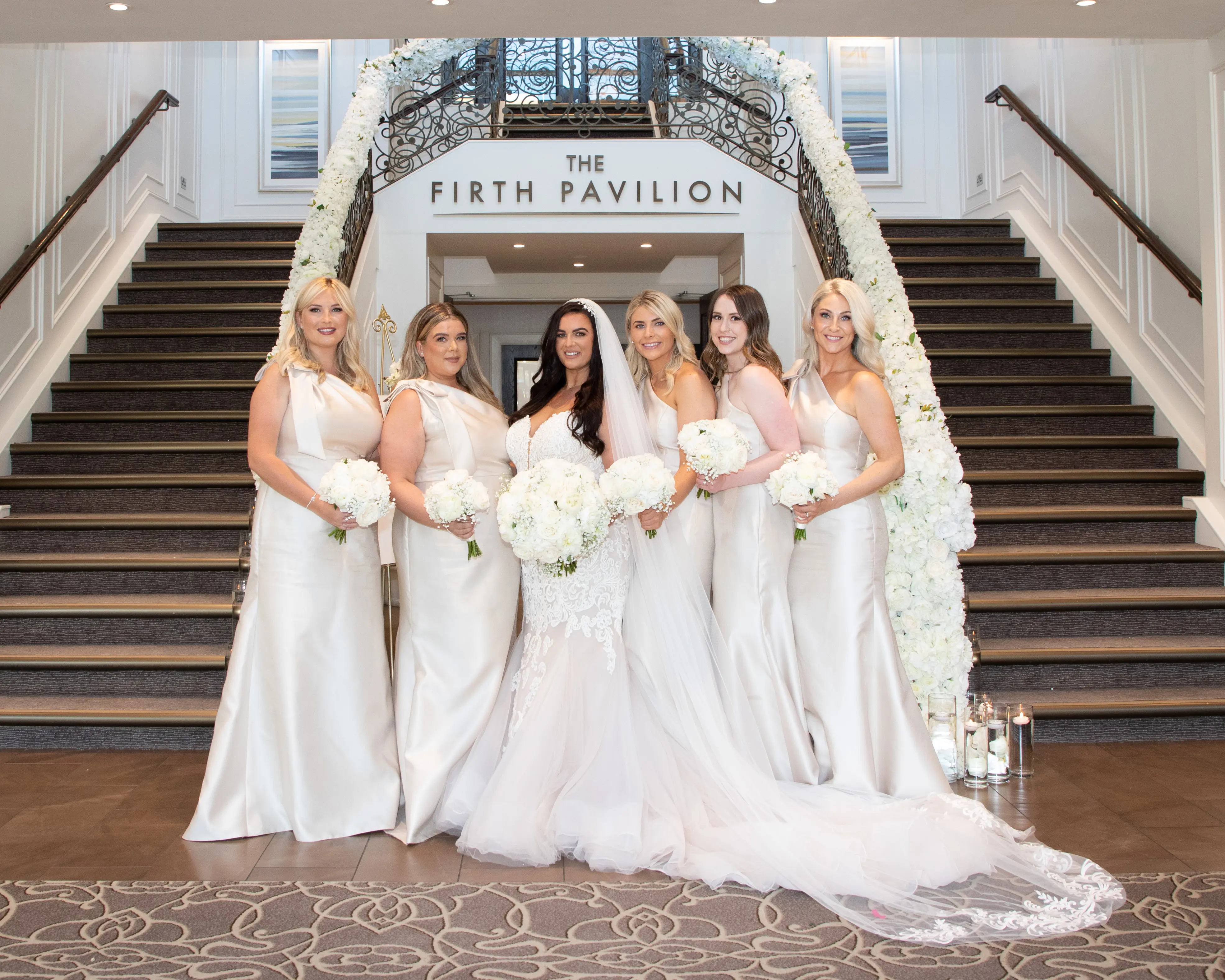 Bride in tulle skirt wedding dress called Alistaire by Maggie Sottero with bridesmaids