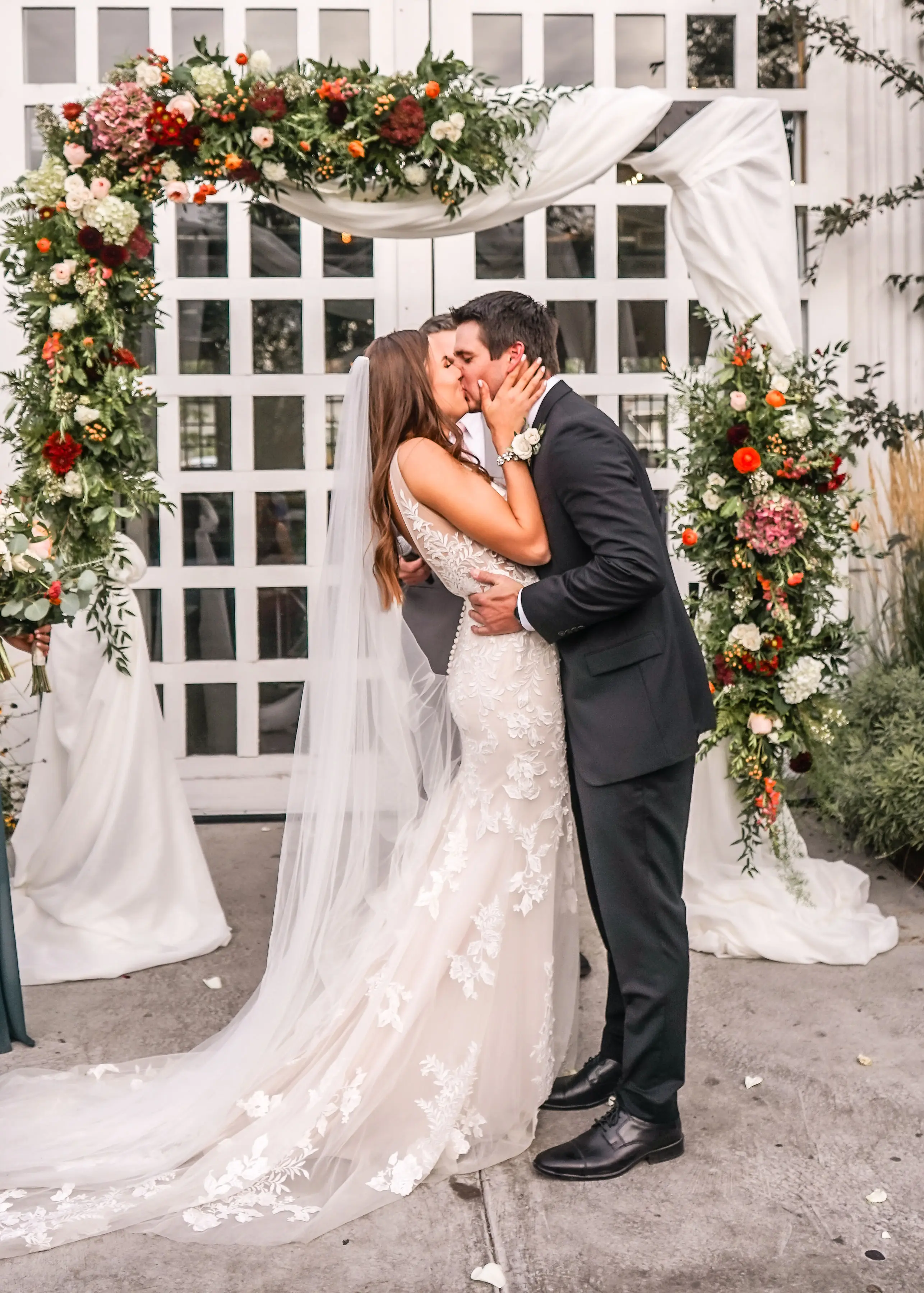Groom with bride wearing sexy fit and flare wedding dress called Greenley by Maggie Sottero.