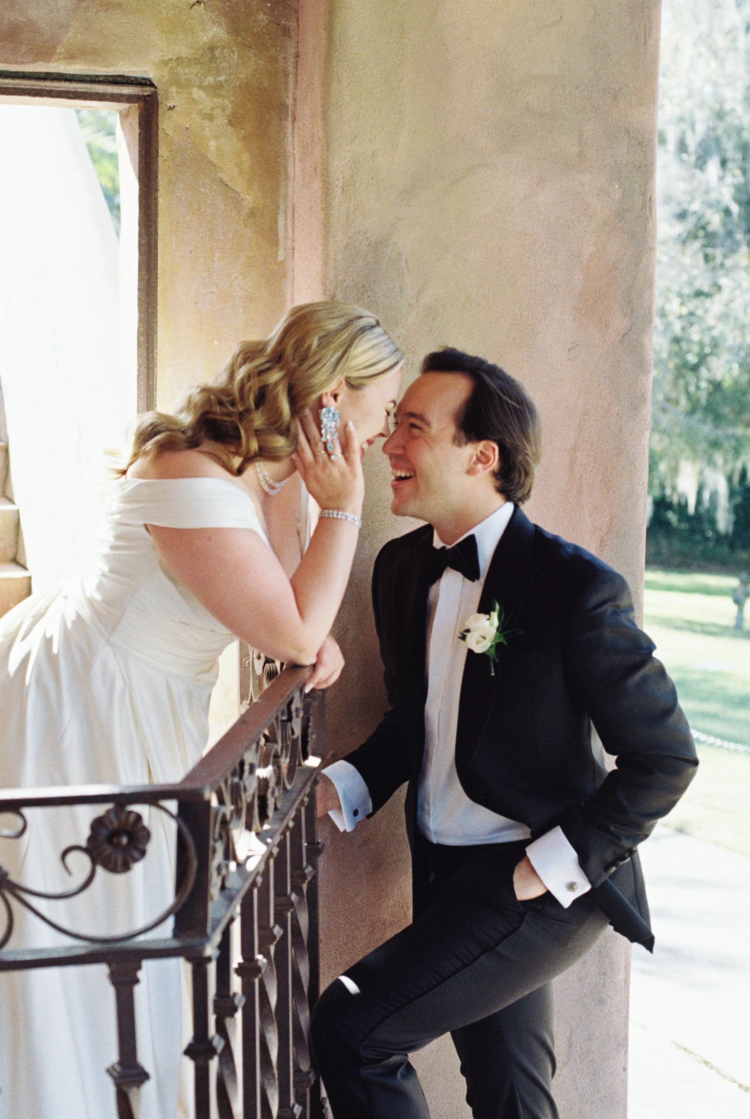 Bride wearing Ekaterina by Maggie Sottero laughing with her husband