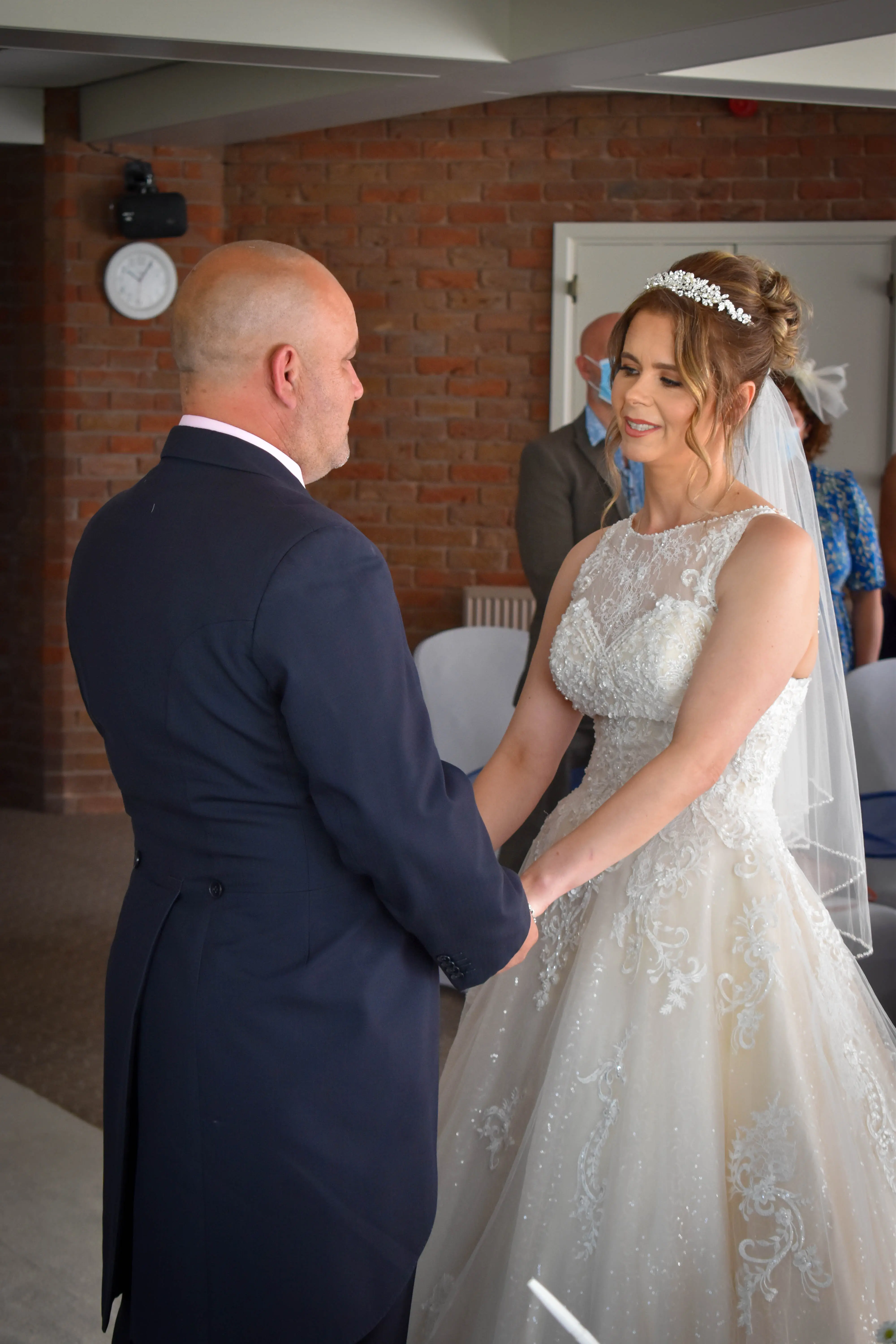 Bride with groom wearing a lace and tulle ballgown wedding dress